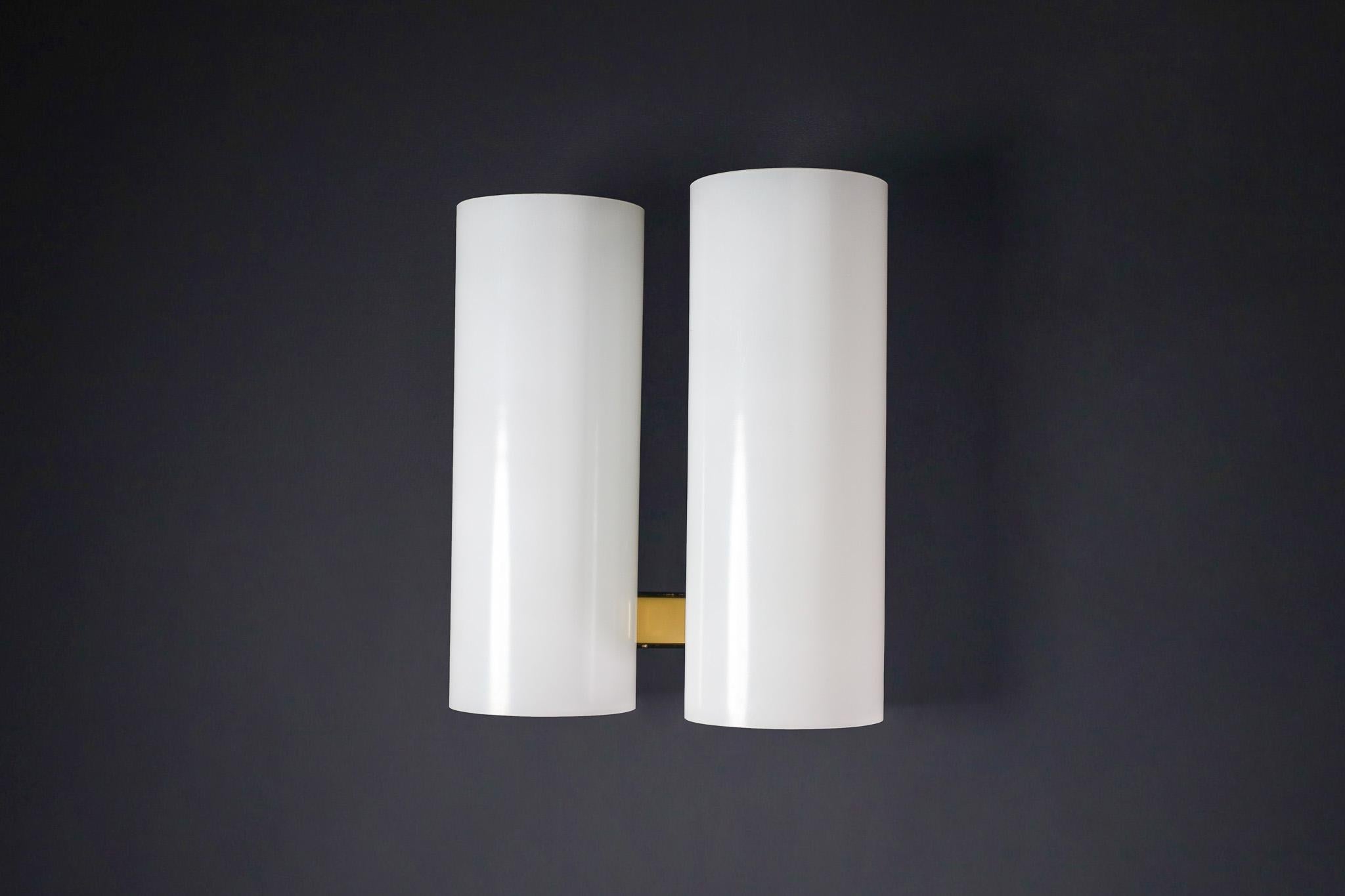 Mid-Century Modern Opaline Glass Wall light by Doria Leuchten, Germany 1960s

This beautiful mid-century modern wall light was designed by Doria Leuchten in Germany during the 1960s. Each sconce features a minimalist yet striking design, composed of
