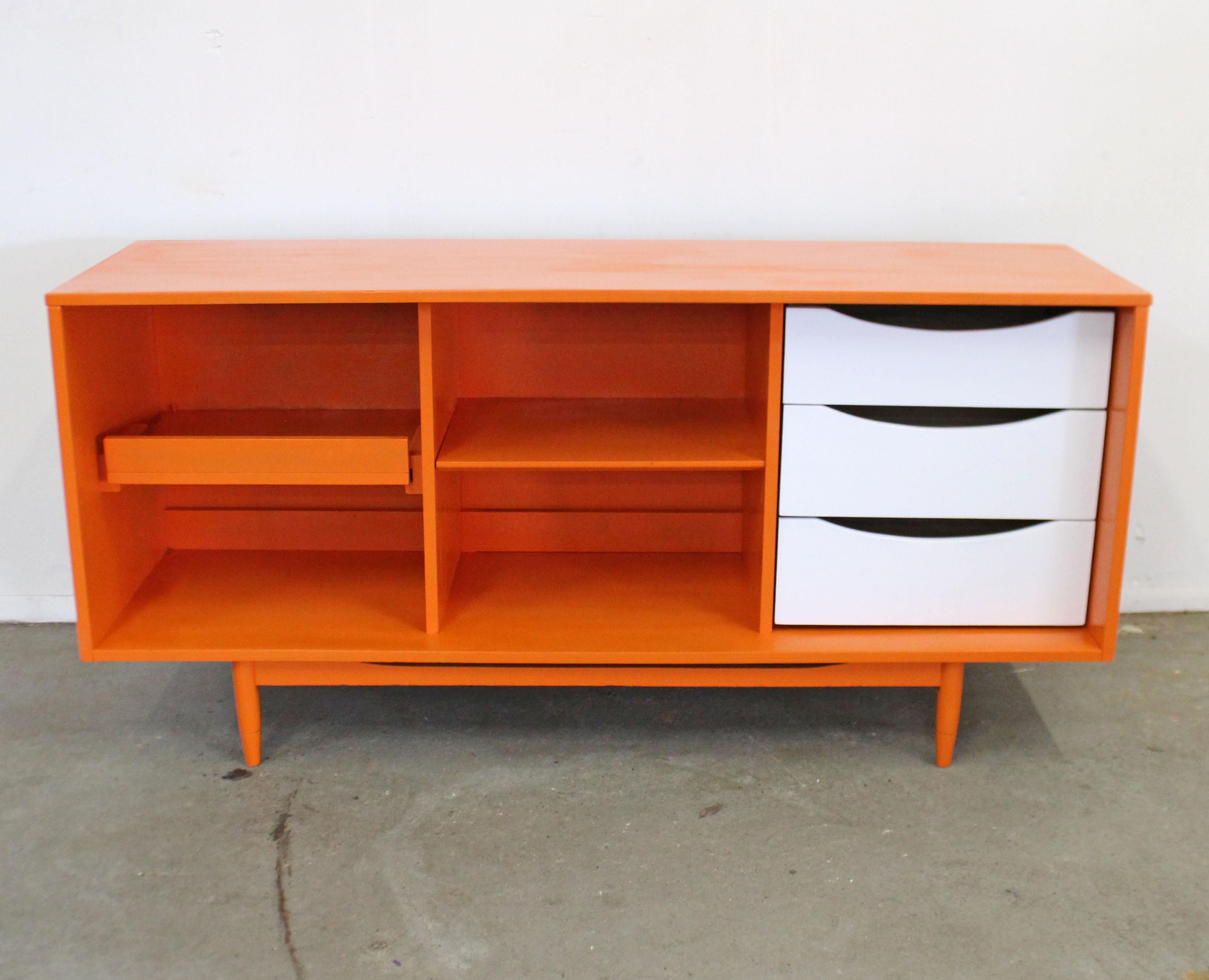 Offered is a vintage Mid-Century Modern open-face credenza. Features an open front with two-toned paint. Includes a pull-out drawer, three drawers, and shelving. It is in good condition for its age, has been modified from its original state with