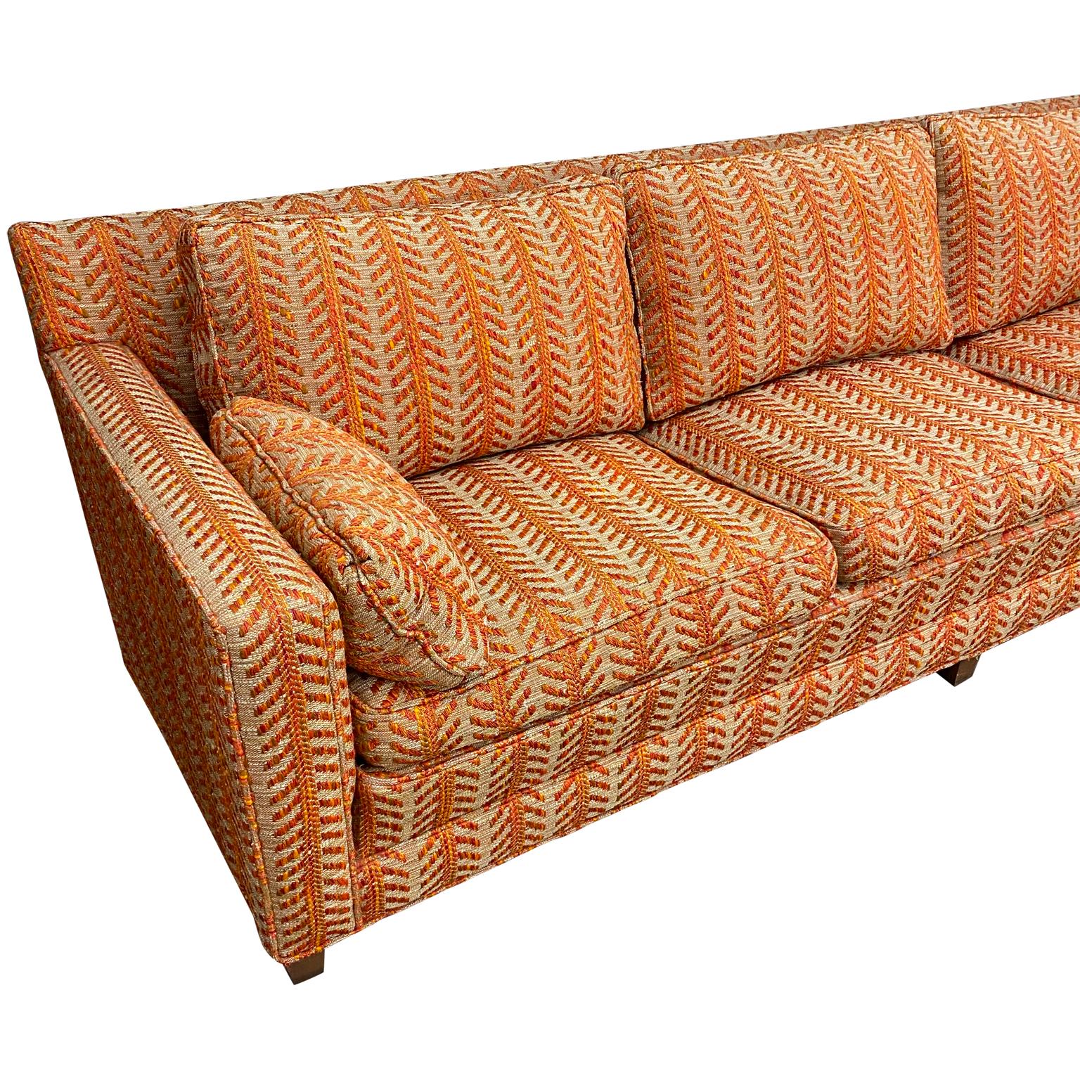 Sink right into this iconic 1960s John Stuart, Inc. long sofa. With it’s colorful orange and creamy chevron patterned fabric, you can fit the whole party on this incredibly deep sofa, stuffed with down and feathers. Original upholstery, original