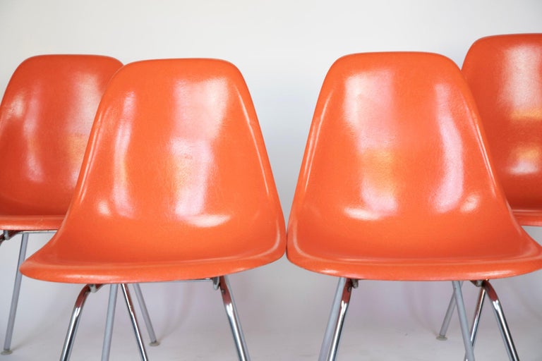 Dining Chairs by Eames, Orange, Fiberglass Shell, USA, 1970s.

A set of four Mid-Century Modern orange coloured fiberglass shell chairs with chrome H base in good vintage condition designed by Charles and Ray Eames for Herman Miller. The H metal