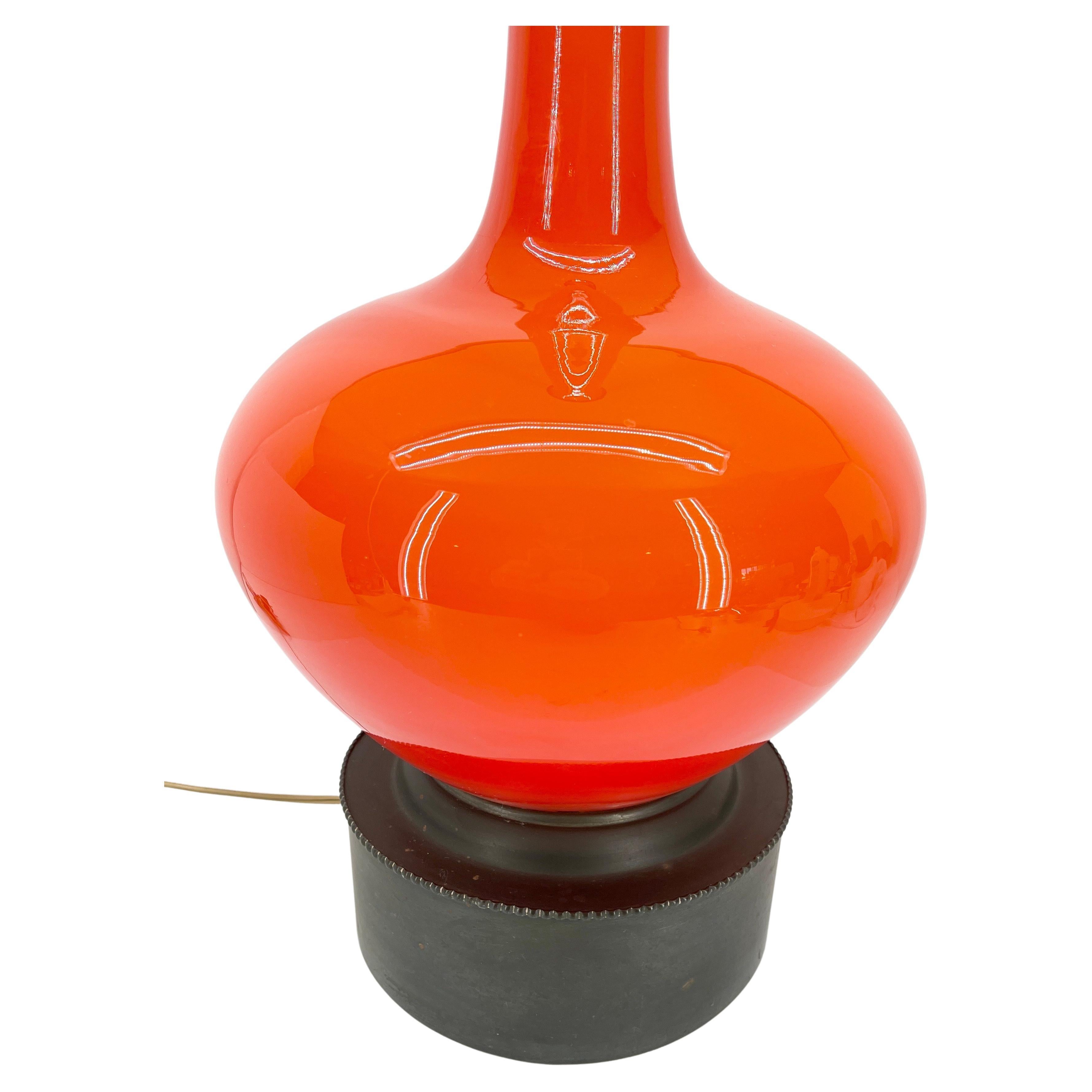 Tall Mid-Century Modern orange glass table lamp, Italy 1960's.
The lamp is very tall and is striking in it's bold orange colored glass. The base is solid vintage brass. The lamp is in very good condition and has been newly rewired. The orange glass