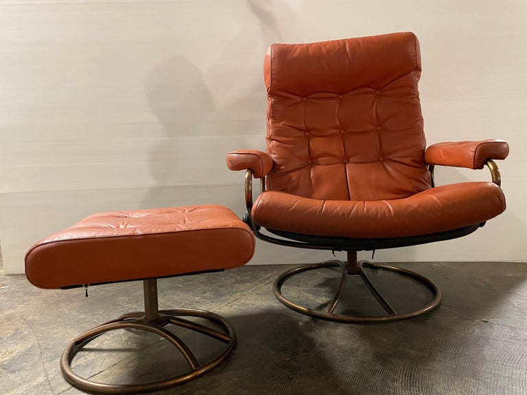 Mid-Century Modern orange leather ekornes stressless recliner chair with ottoman. Norwegian.