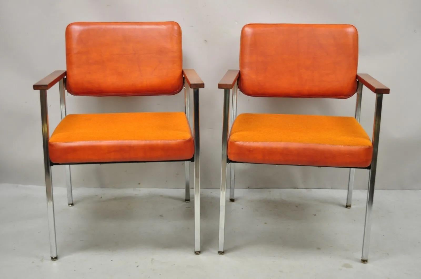 Mid Century Modern orange Naugahyde chrome frame lounge arm chairs by Malibu Ind. Item features chrome metal frame, orange naugahyde and fabric upholstery, solid wood armrest, very nice vintage pair, clean modernist lines, great style and form.