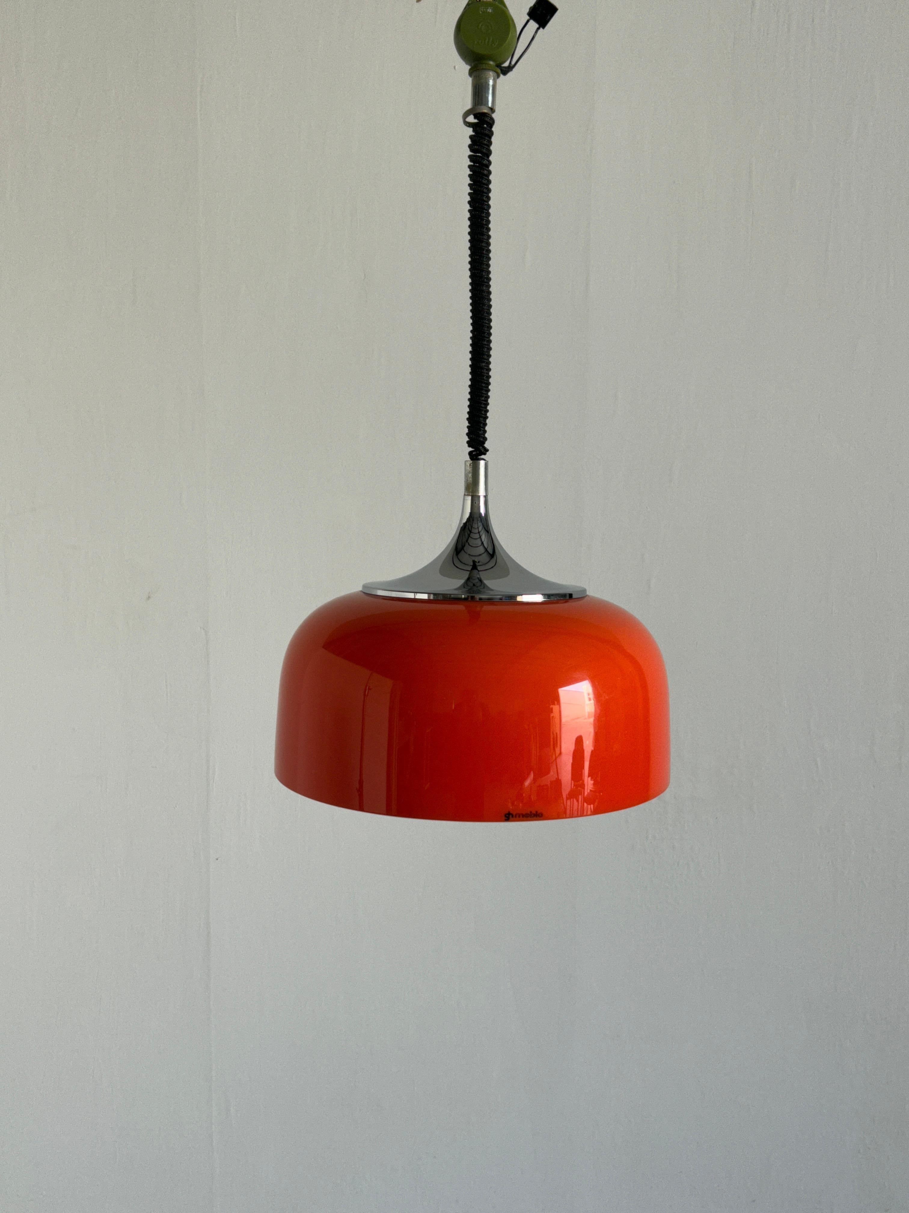 A large and beautiful orange pendant light produced by Meblo for Harvey Guzzini Studio throughout the 1960s-1970s. Made from chromed metal and plastic. In rare orange edition.
Adjustable height with the vintage extension mechanism.

In good vintage