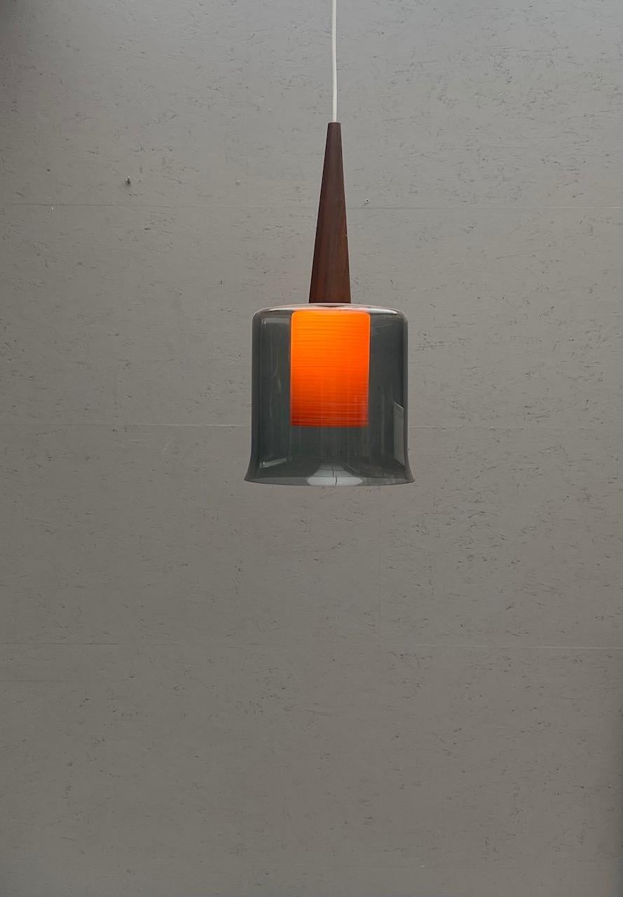 Mid-Century Modern orange scandinavian hanging lamp. 
A pair available 
Price per piece.