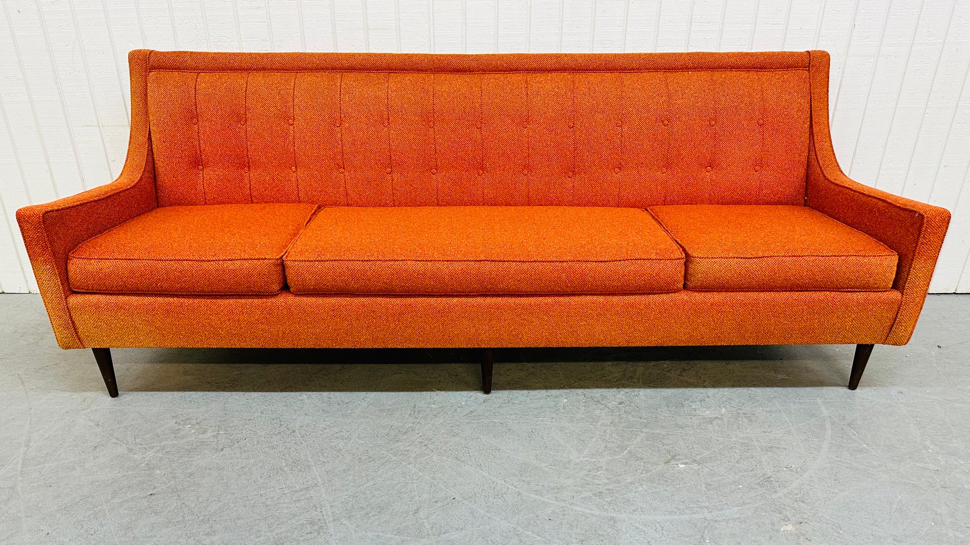 This listing is for a Mid-Century Modern Orange Sofa. Featuring space for 3-4 people to sit, removable cushions, walnut legs, and a beautiful original orange upholstery.