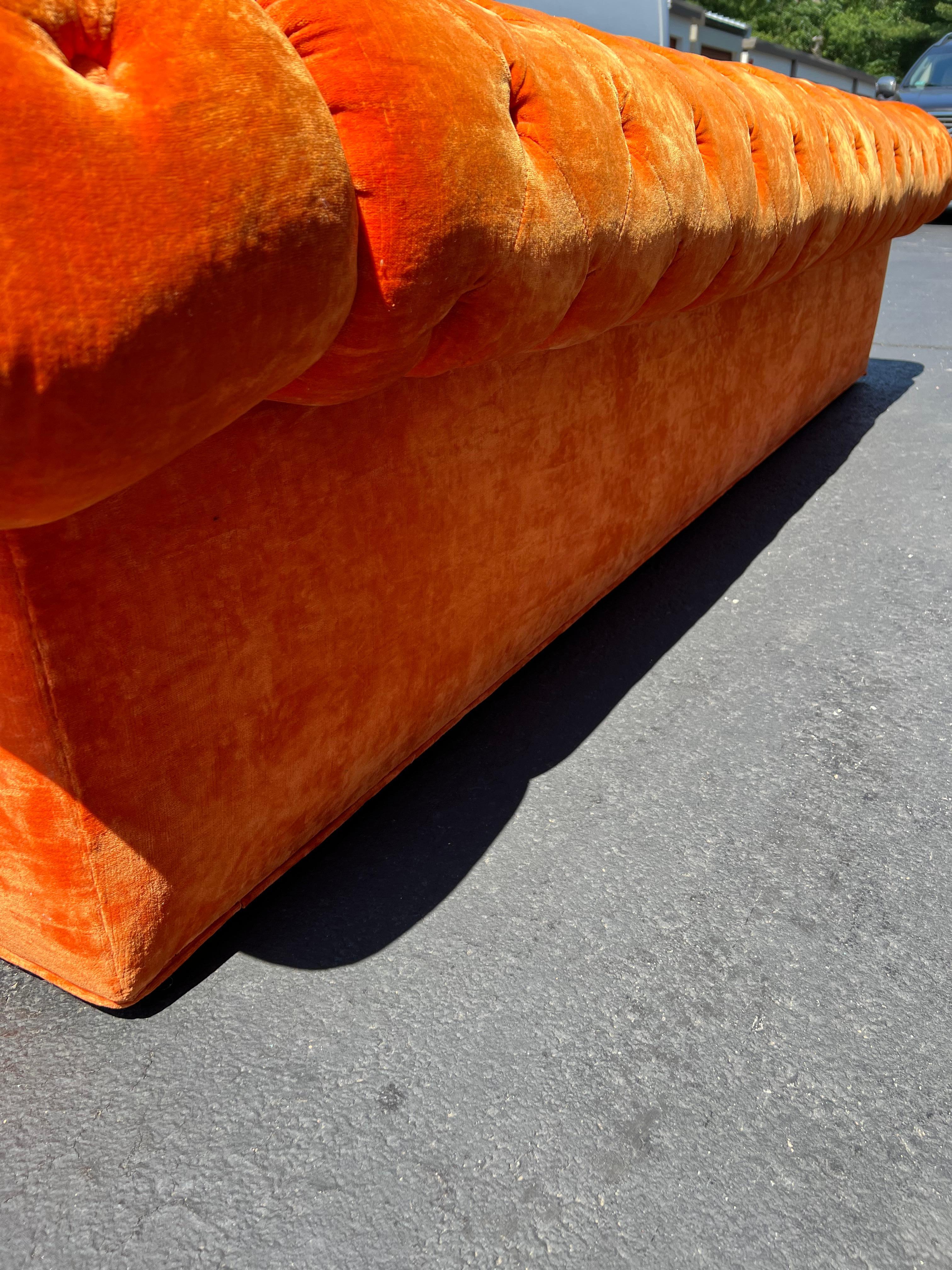 orange tufted couch