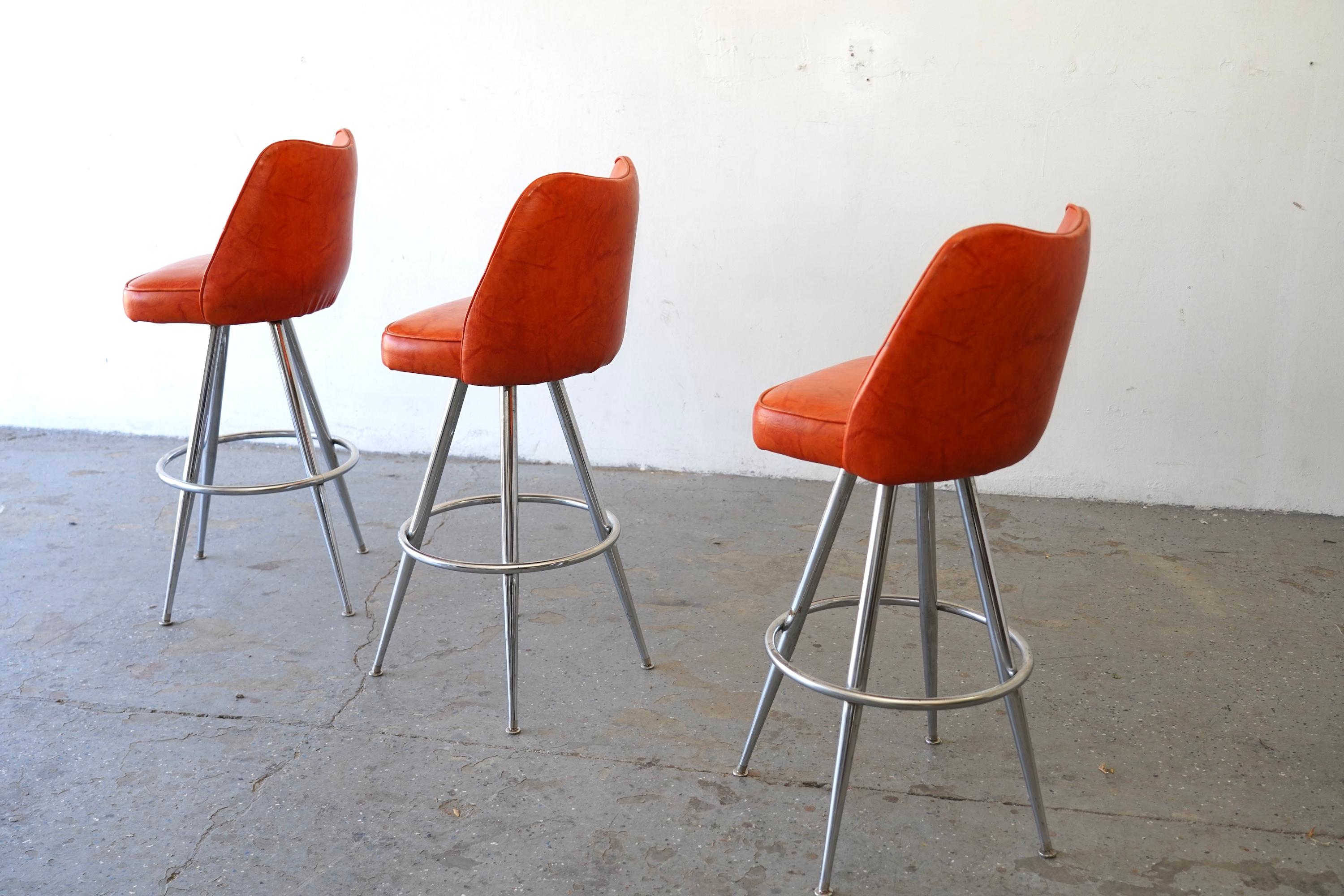 American Mid-Century Modern Orange Vinyl & Chrome Swivel Bar Stools — Set of 3 For Sale
