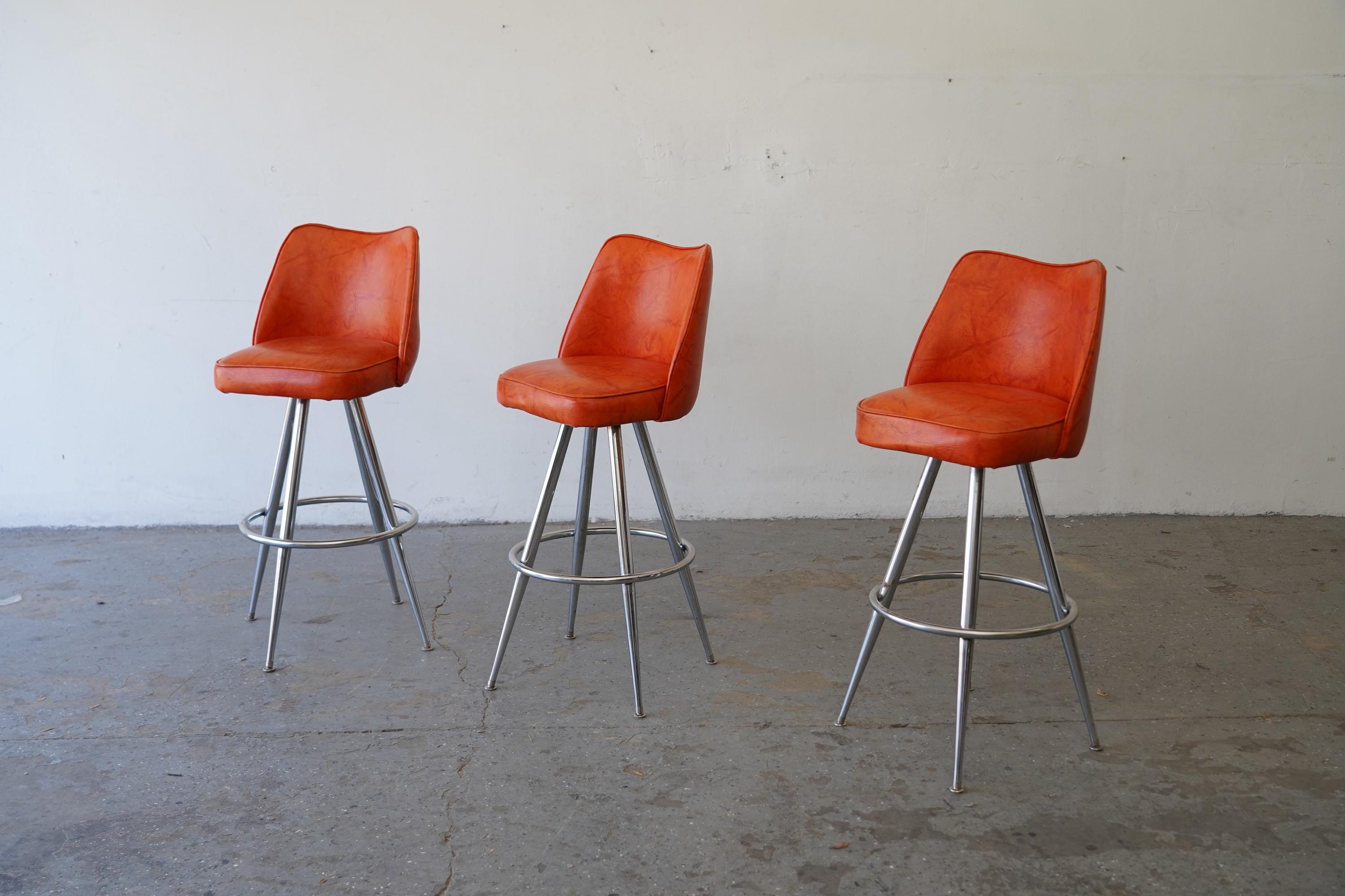 Mid-Century Modern Orange Vinyl & Chrome Swivel Bar Stools — Set of 3 In Good Condition For Sale In Las Vegas, NV
