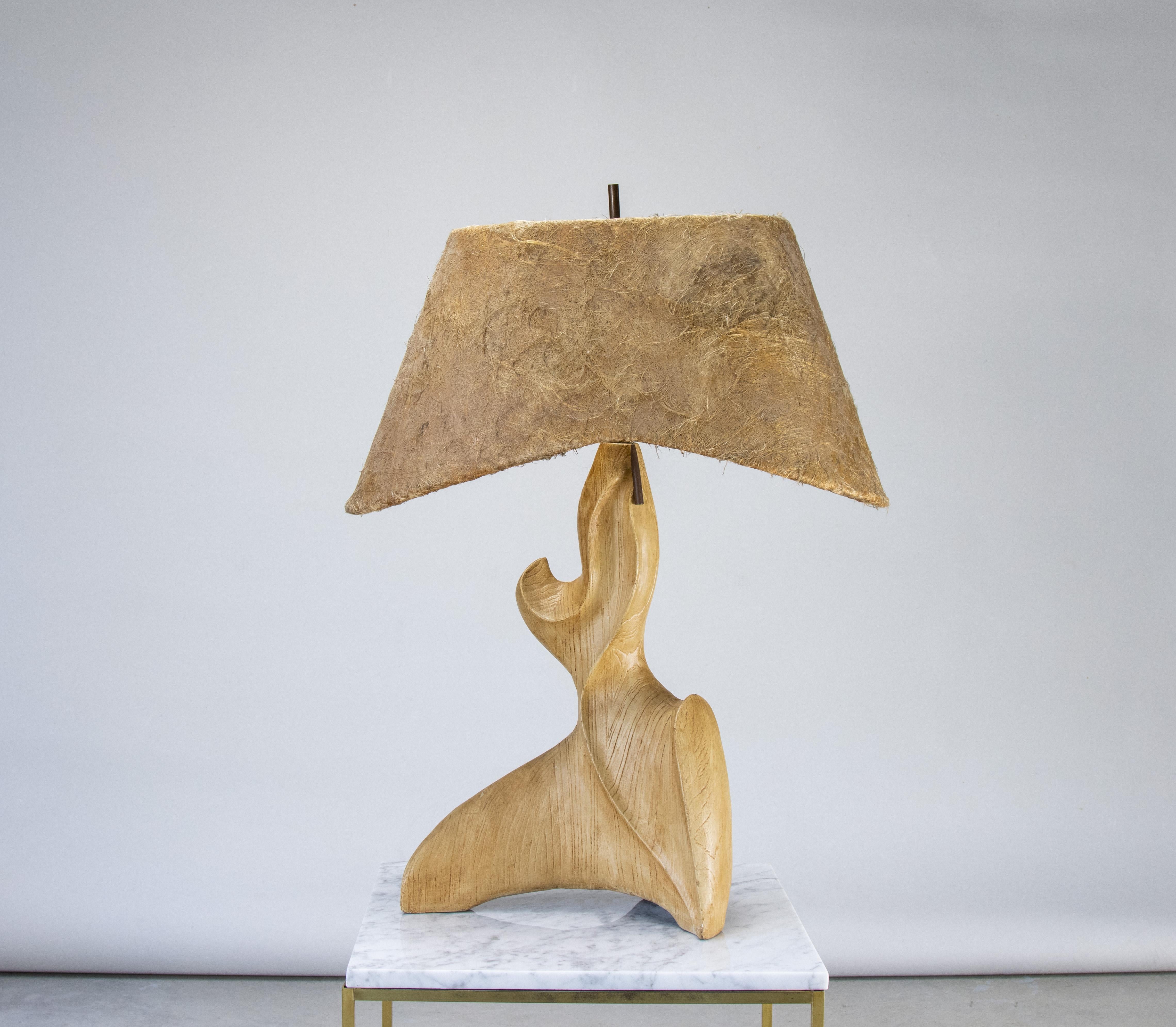 A truly unique organic shaped table lamp circa 1950’s.  Large at 33.5” tall and 25.5” wide.  The lamp is made of heavy ceramic with a wood textured design. The horsehair shade with curved edges adds a great texture.  