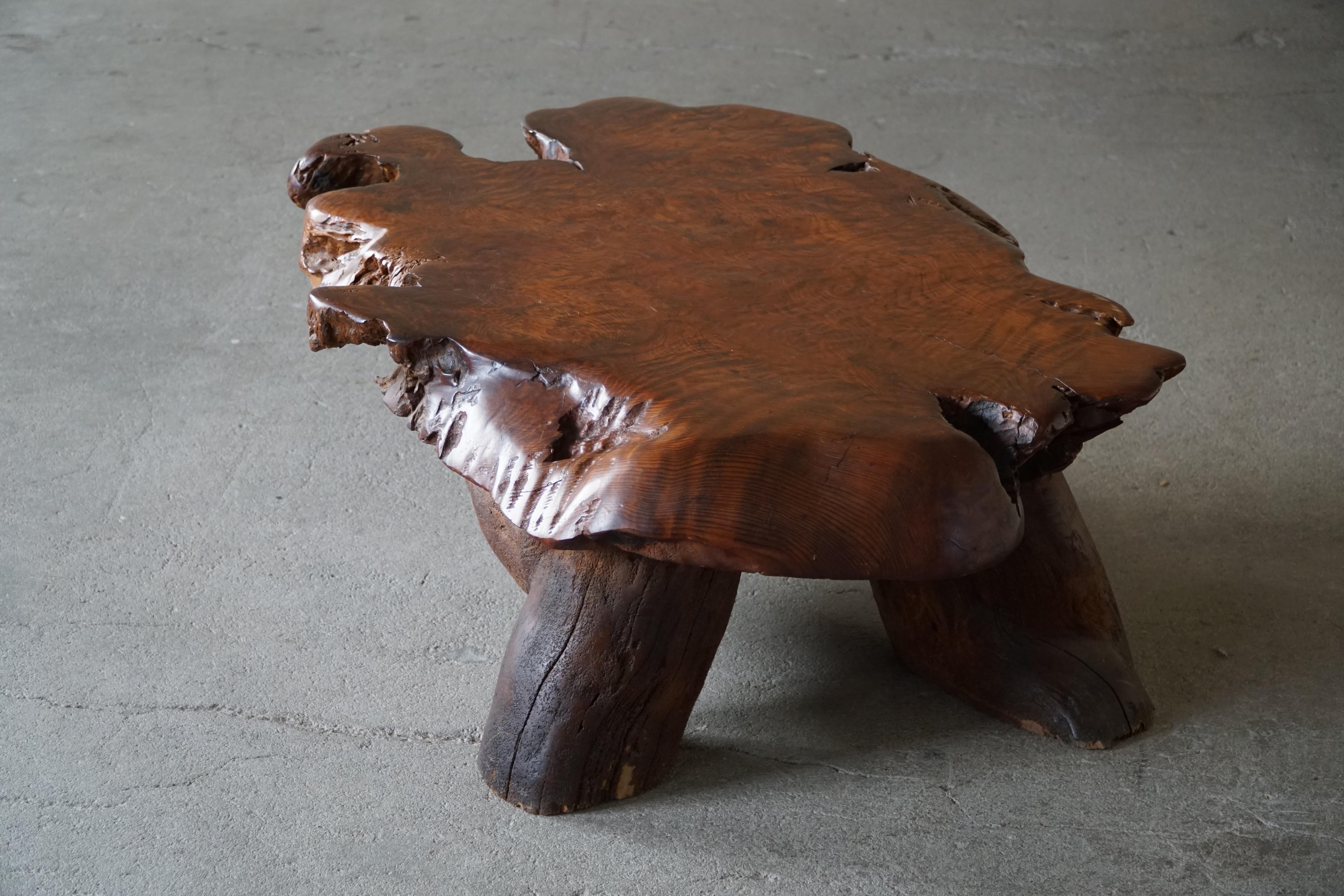 A unique wabi sabi coffee table carved from a large wooden piece. Minor signs of wear.
This intriguing table will complement many interior styles. A Modern, Scandinavian, Classic or an Bohemian home decor.

This great Brutalist object is perfect