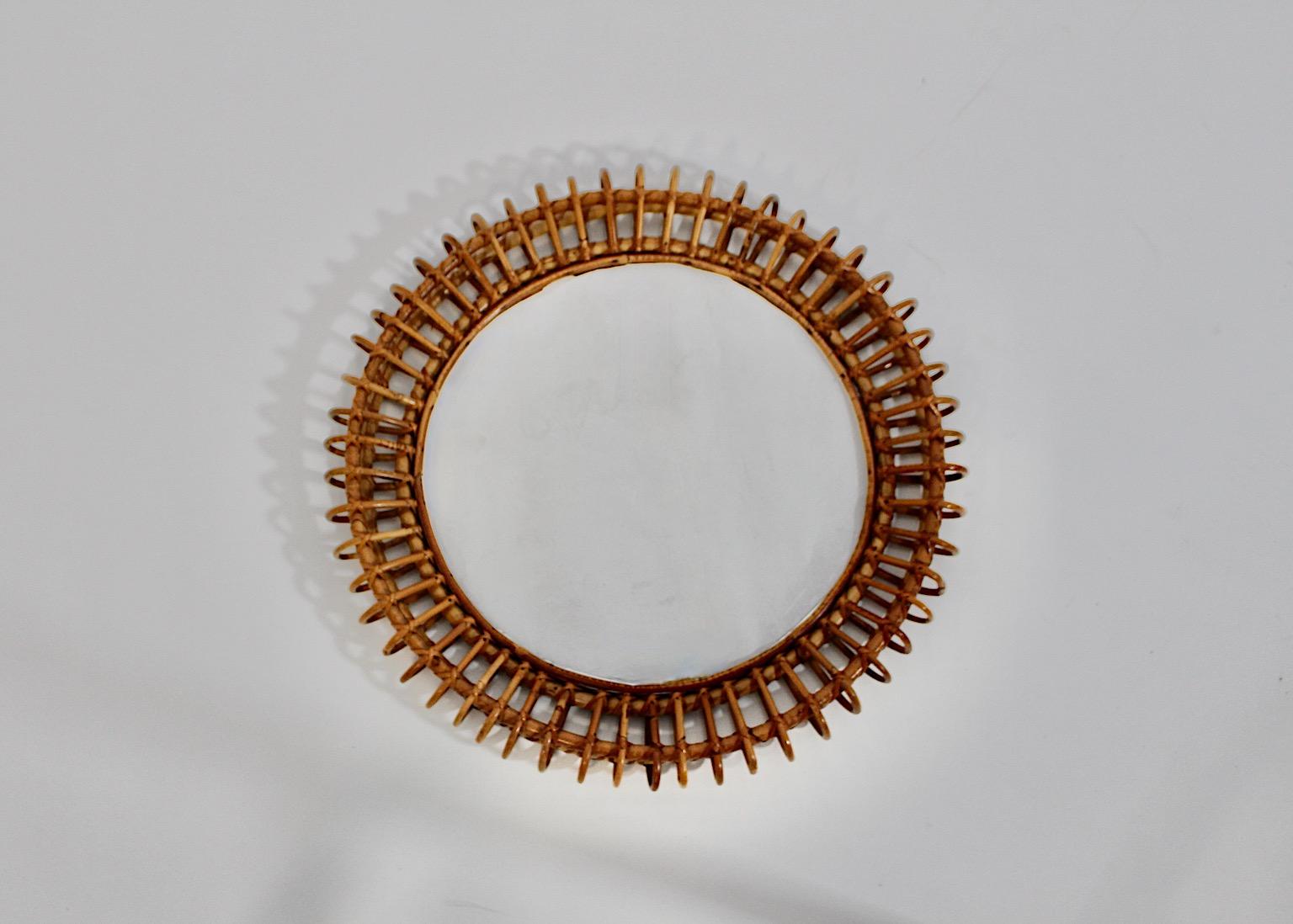 Mid Century Modern Organic Vintage Riviera style sunburst mirror wall mirror from rattan and mirror glass circular like 1960s Italy.
An amazing circular like wall mirror from rattan with slightly curved beams like sunbursts and mirror glass.
While