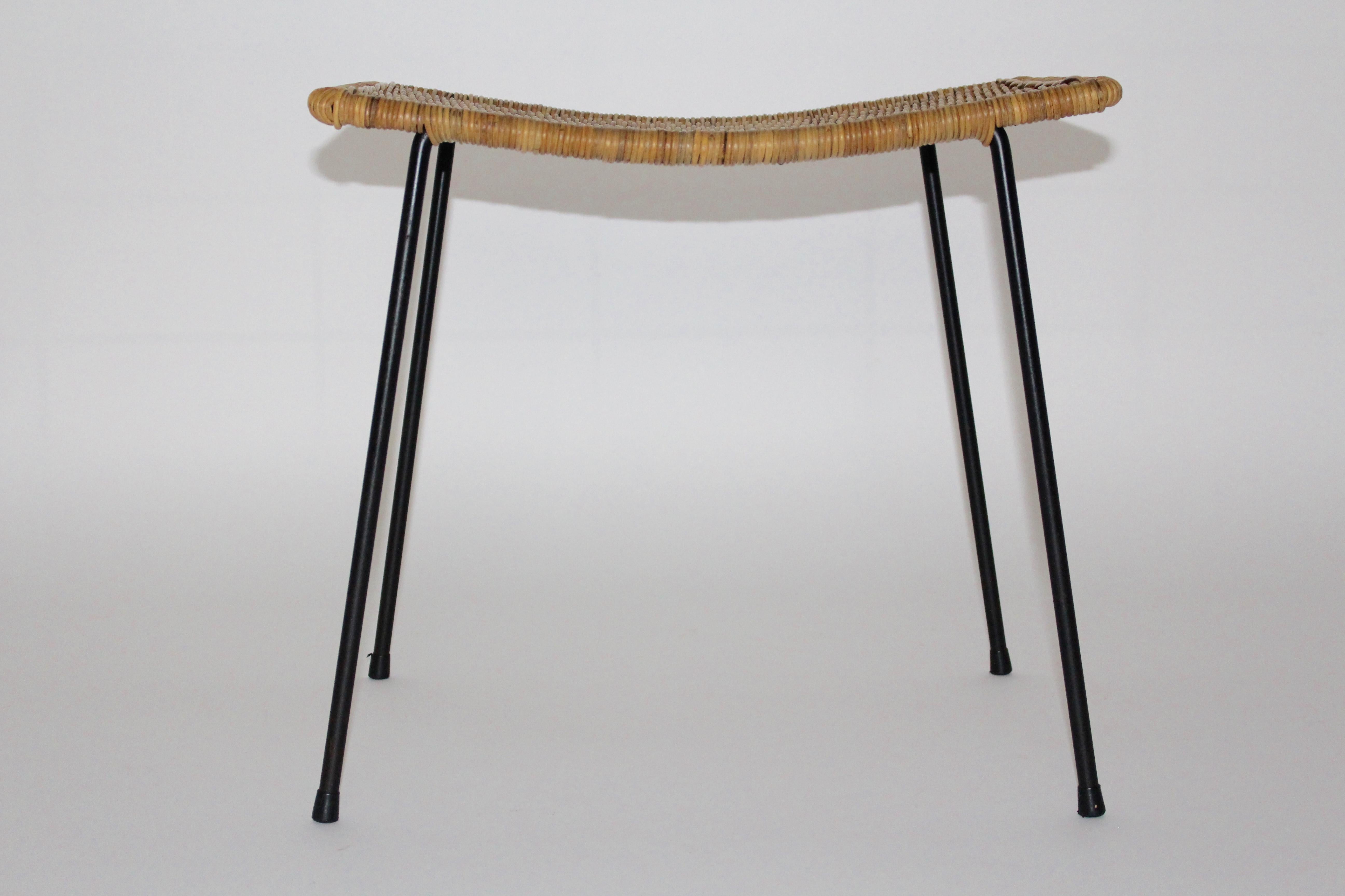 Mid-Century Modern vintage stool from woven rattan and black metal feet designed and manufactured Vienna 1950s.
A stunning and comfortable lightweight stool from woven rattan with four black lacquered metal feet with a slightly curved seat.
This