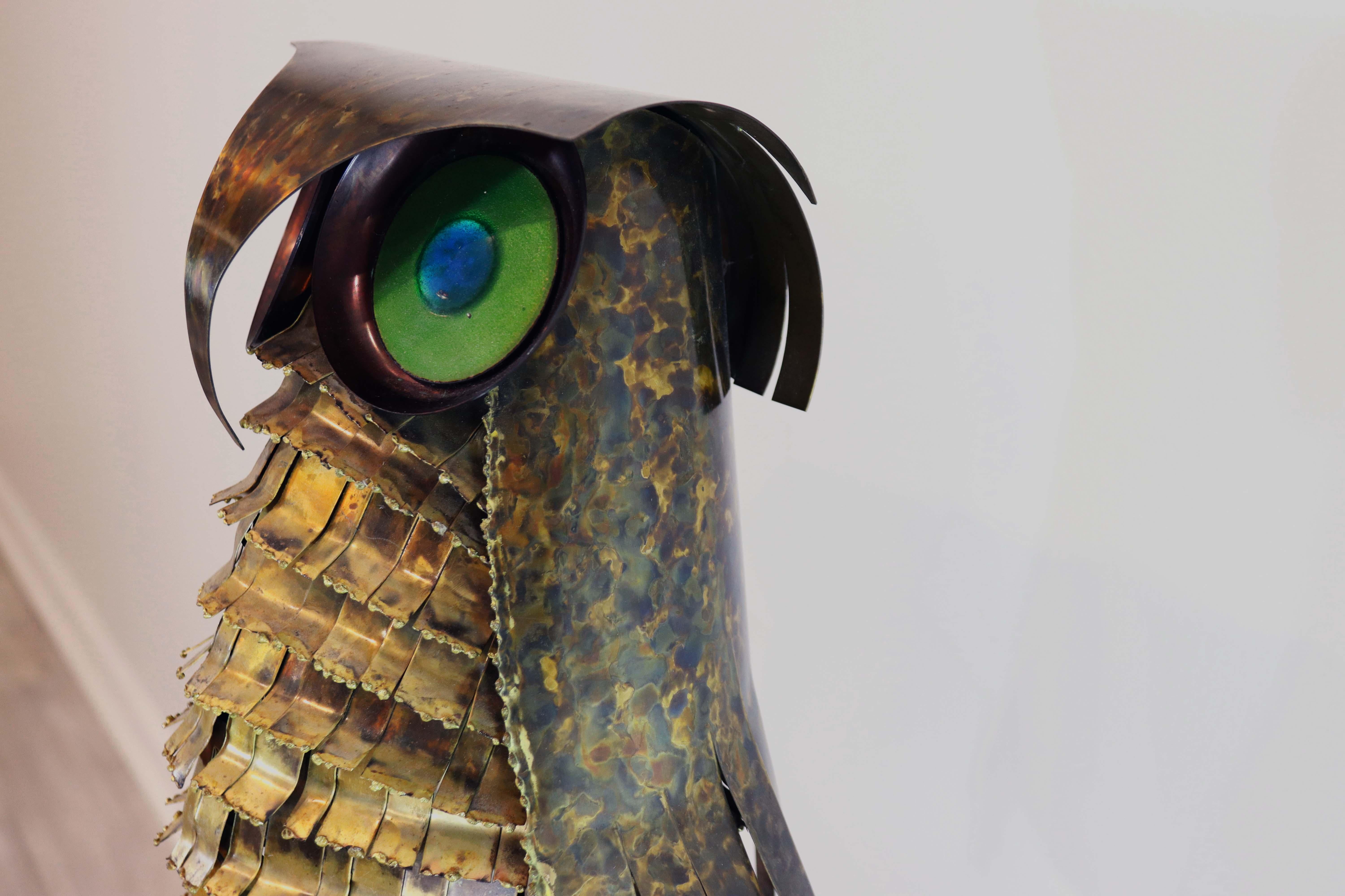 Richly patinated, this brass torch cut metal owl sculpture with detailed with multi color enameled eyes is exemplary work of Curtis Jere. 

Well known to many for producing some of the most iconic metal work, art and sculpture in the mid century,