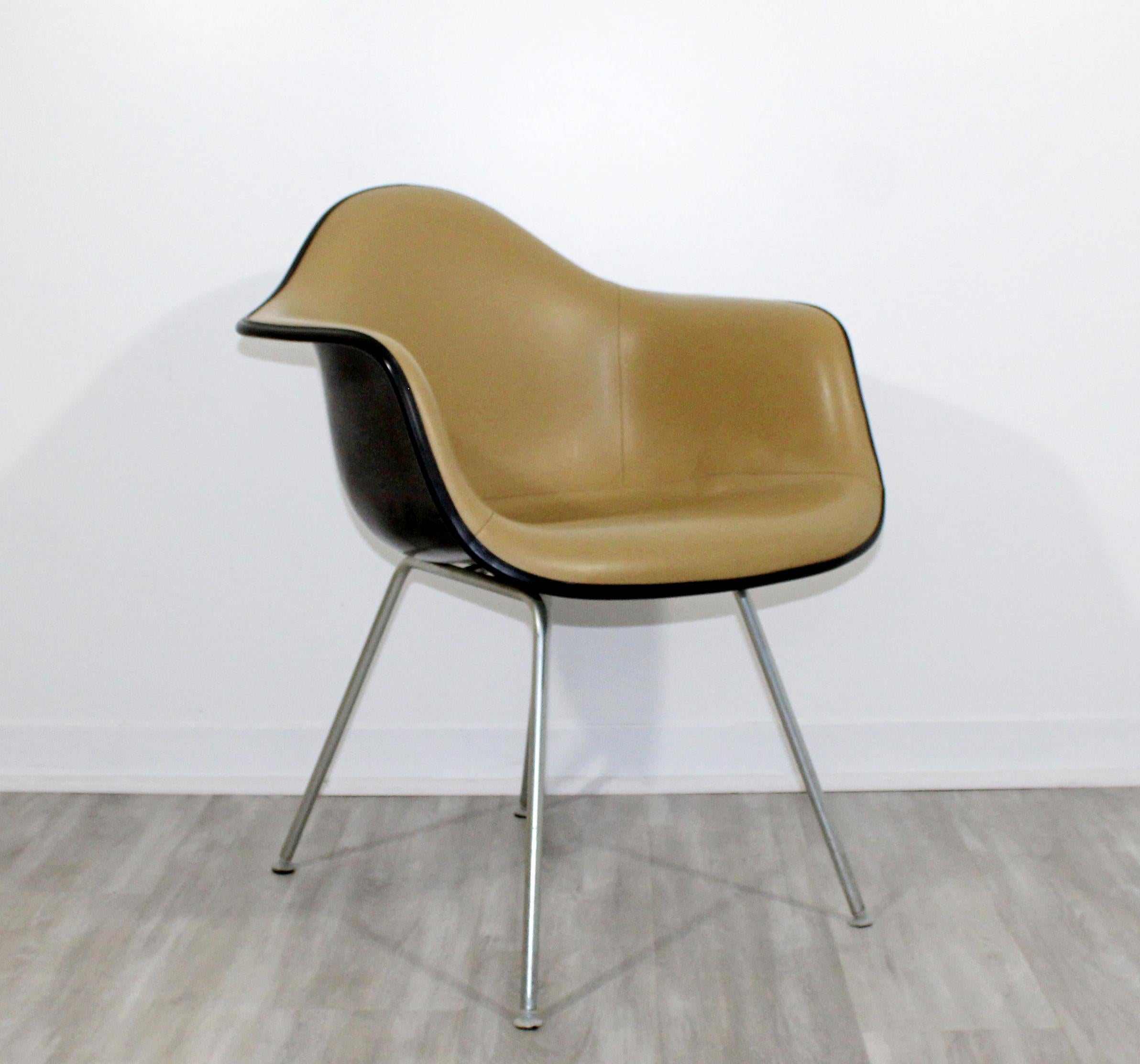For your consideration is an original, shell armchair, with a beige Naugahyde upholstery, by Eames for Herman Miller, circa the 1960s. In excellent vintage condition. The dimensions are 25