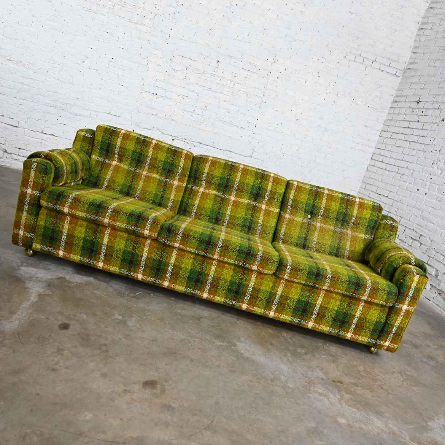 Handsome Mid-Century Modern green & gold plaid sofa by Mastercraft of Omaha. Beautiful condition, keeping in mind that this is vintage and not new so will have signs of use and wear. There is some wear, holes, & stains on the decking but all the