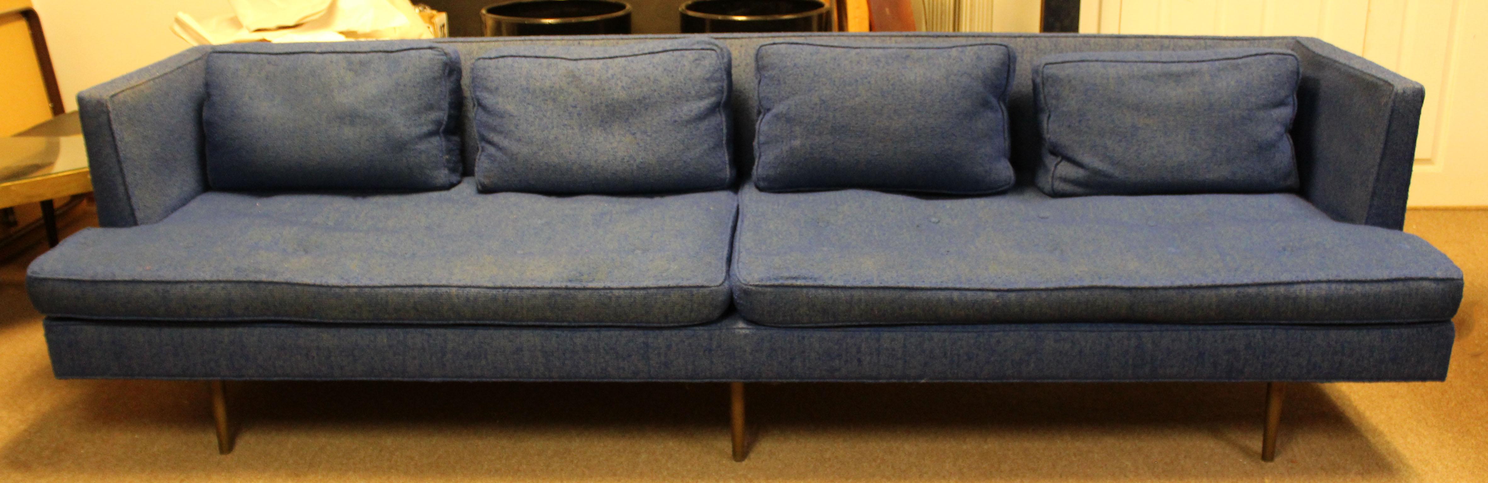 For your consideration is a stunning, indigo blue sofa, with polished brass legs, by Edward Wormley for Dunbar, circa 1950s. Structurally in good condition, however cushions need re-foaming. The dimensions are 108