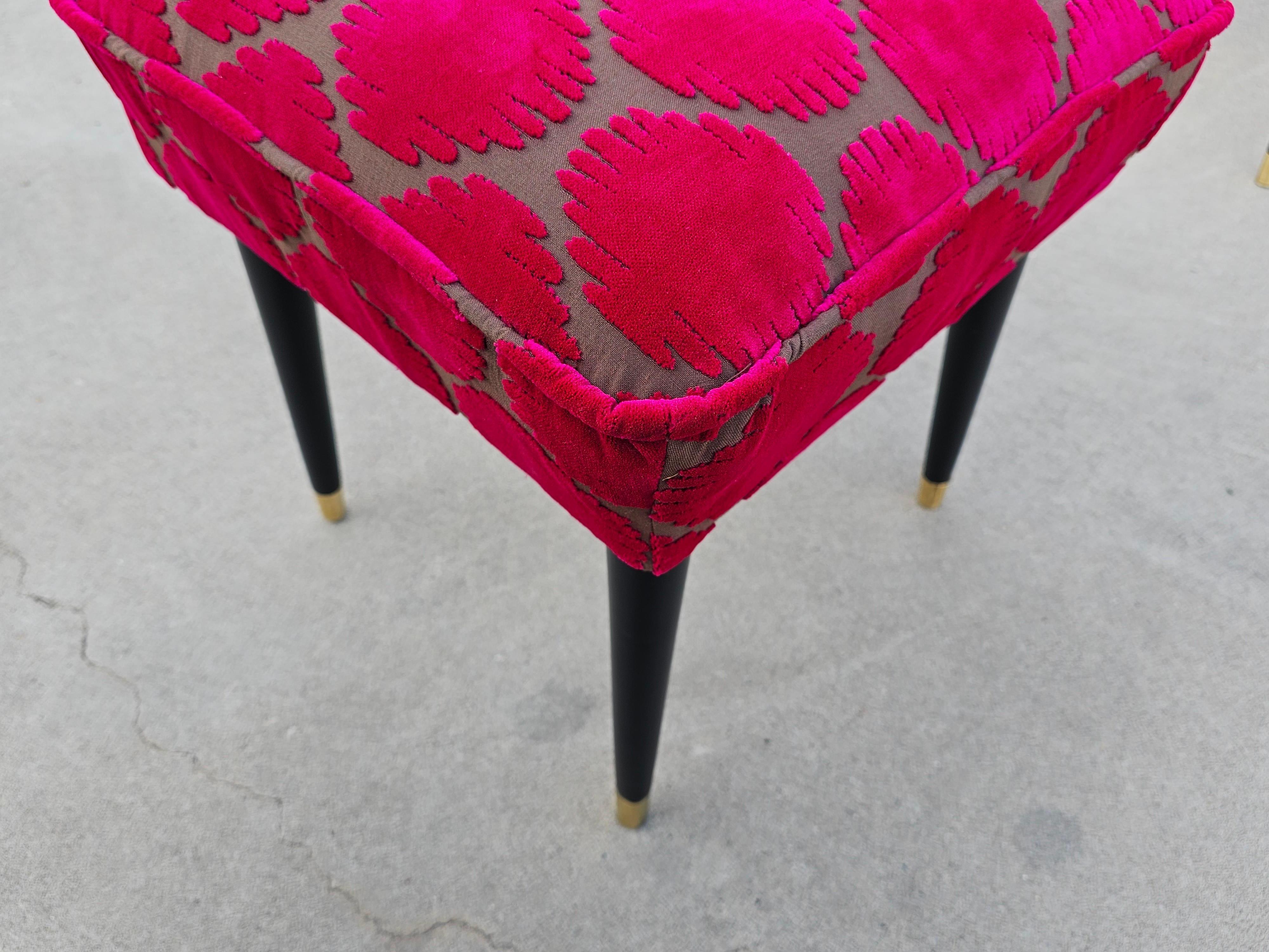 In this listing you will find two Mid-Century Modern Ottomans or Stools. The stools are fully refurbished and reupholstered in fuchsia polka dot velvet, inspired by the work of the Japanese artist Yayoi Kusama. The fibrant fabric is a true eye candy