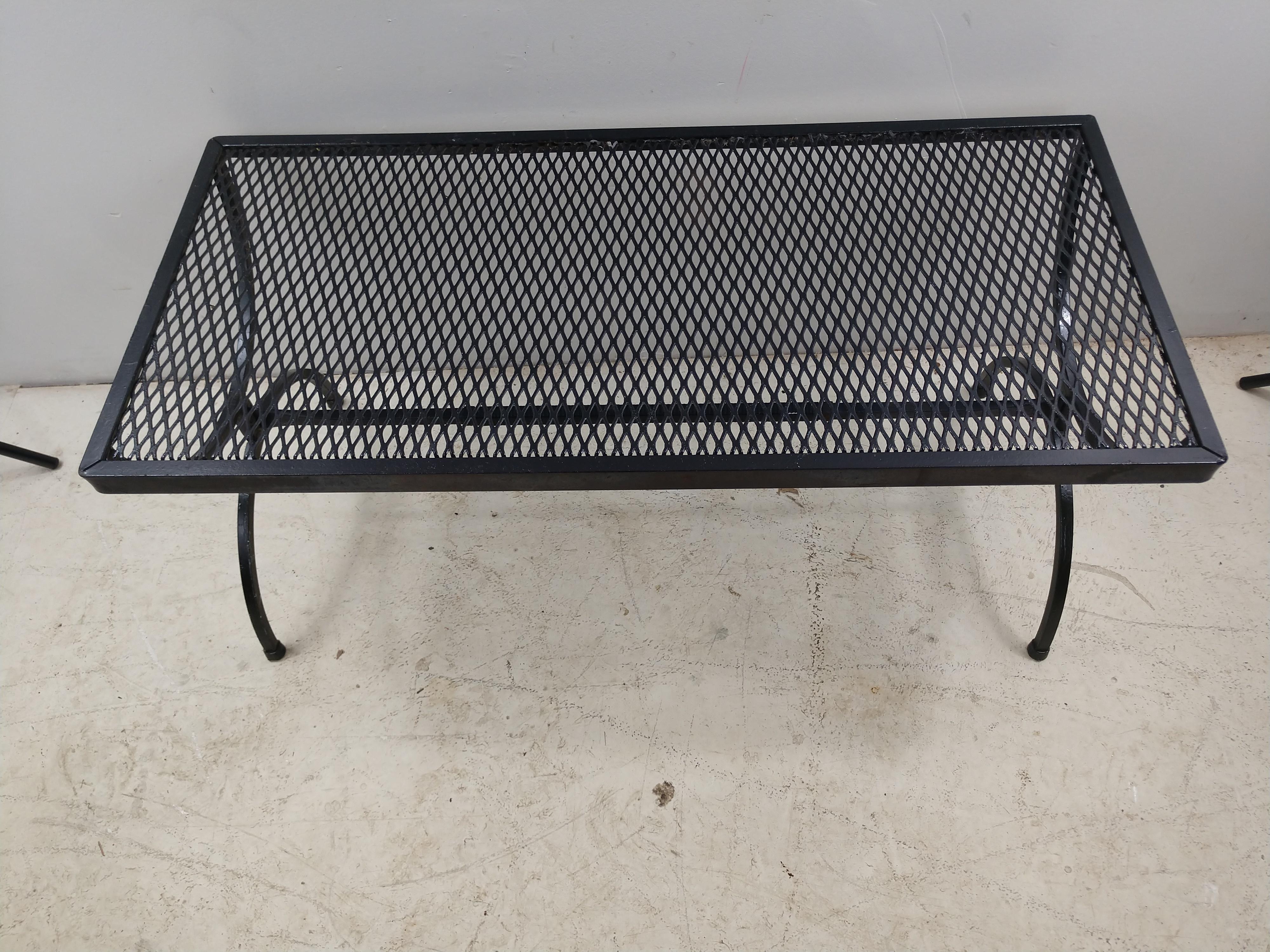 Very cool shape, oblong with great form to the legs. Mesh top and has plastic feet for protection. Recently sprayed black. Salterini furniture is always construction well and with great design.