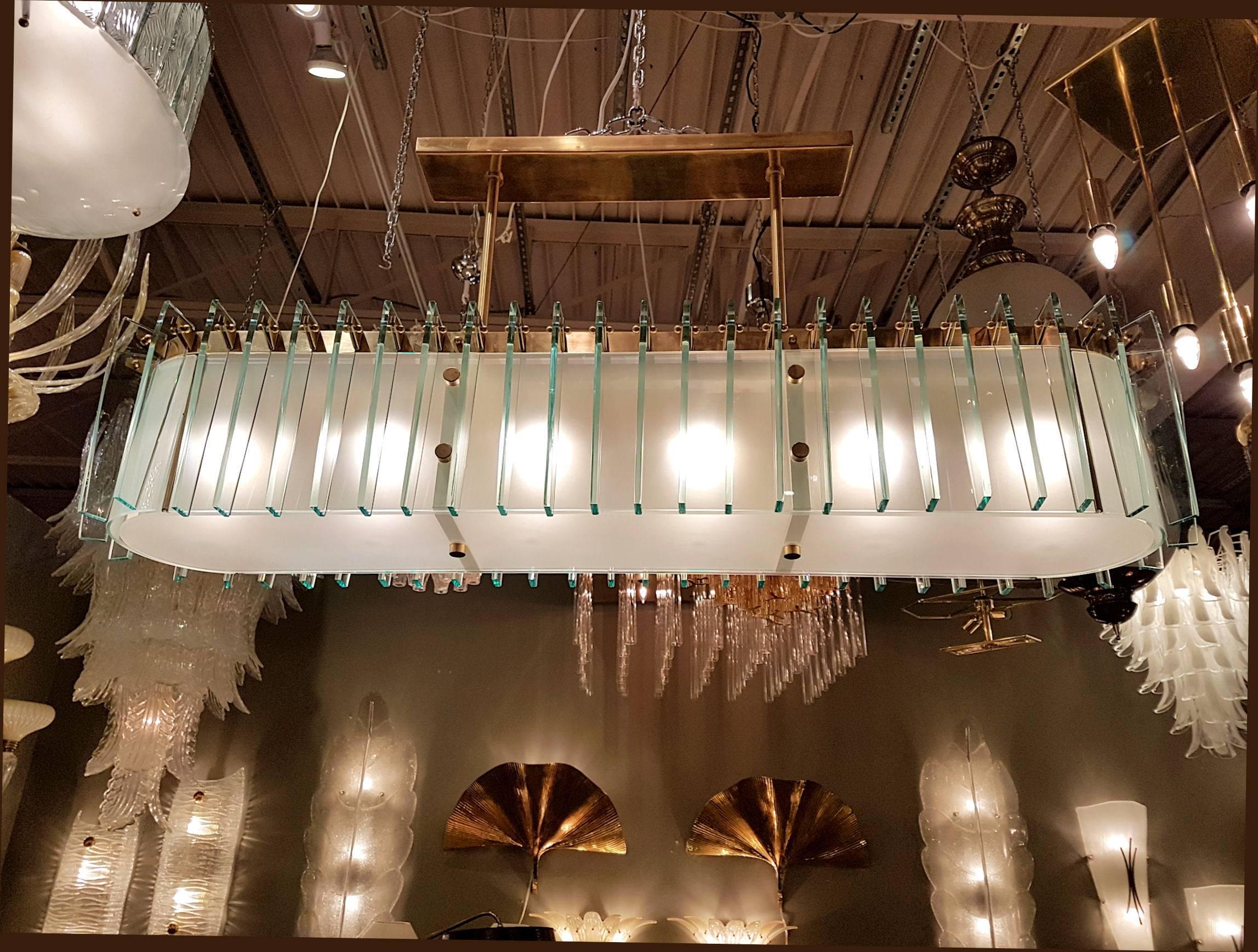 Large narrow oval chandelier by Dominici with translucent white glass panels trimmed in thick green glass panels mounted on a brass frame. Newly rewired to hold six candelabra base lights.