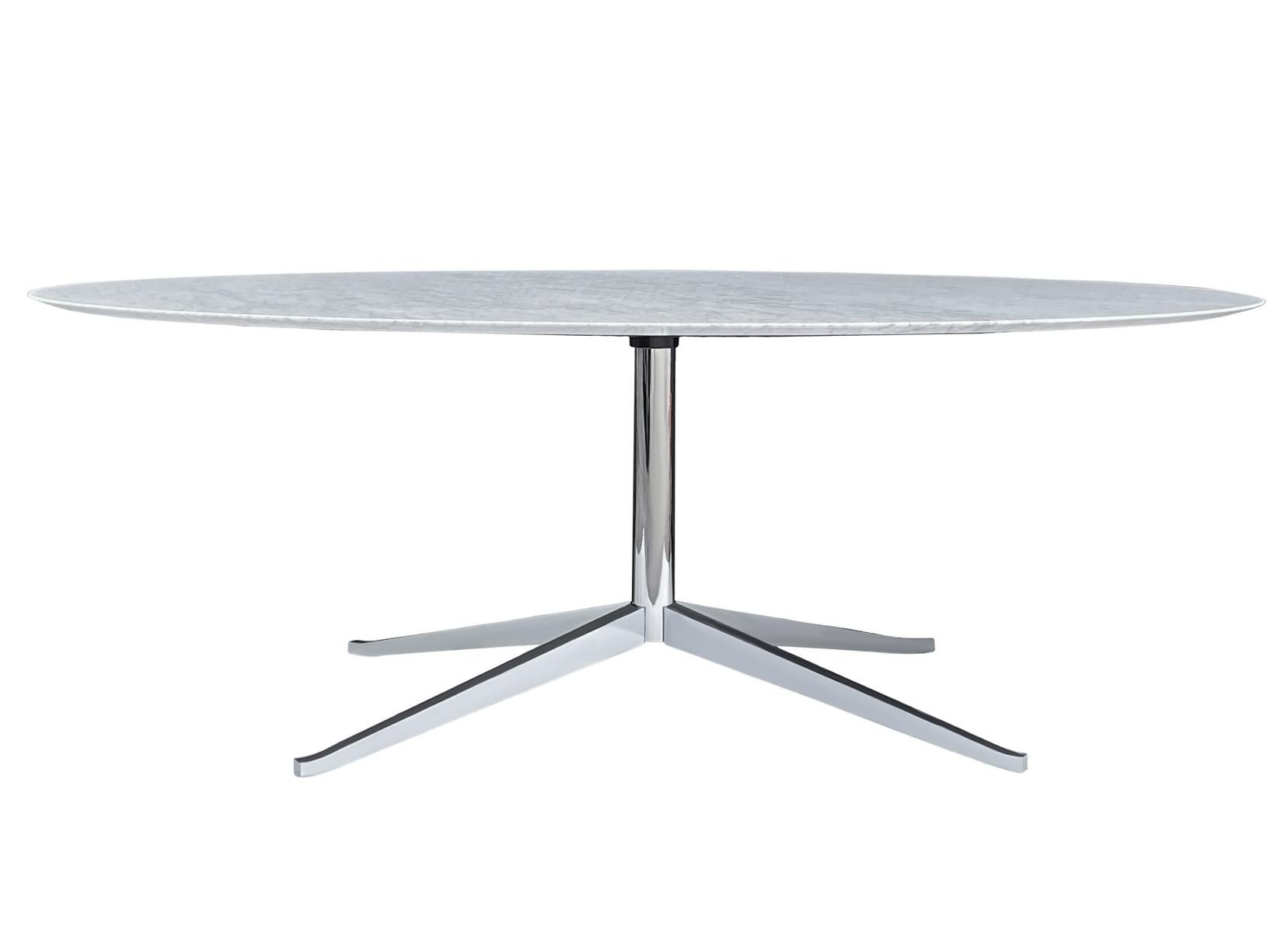 An elegant executive table designed by Florence Knoll and produced by Knoll. It features a beautiful polished white & gray Carrara marble top and a chrome-plated star base. This was one of the most expensive marble options for this table. Signed