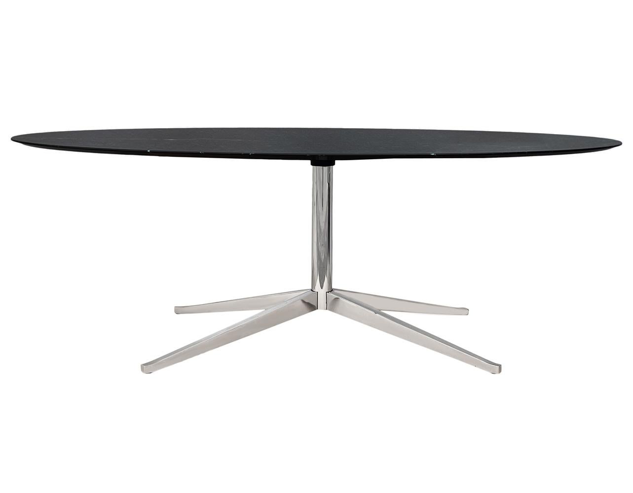 An elegant executive table designed by Florence Knoll and produced by Knoll. It features a beautiful high gloss Nero Marquina black marble top and a chrome-plated star base. This was one of the most expensive marble options for this table. Signed