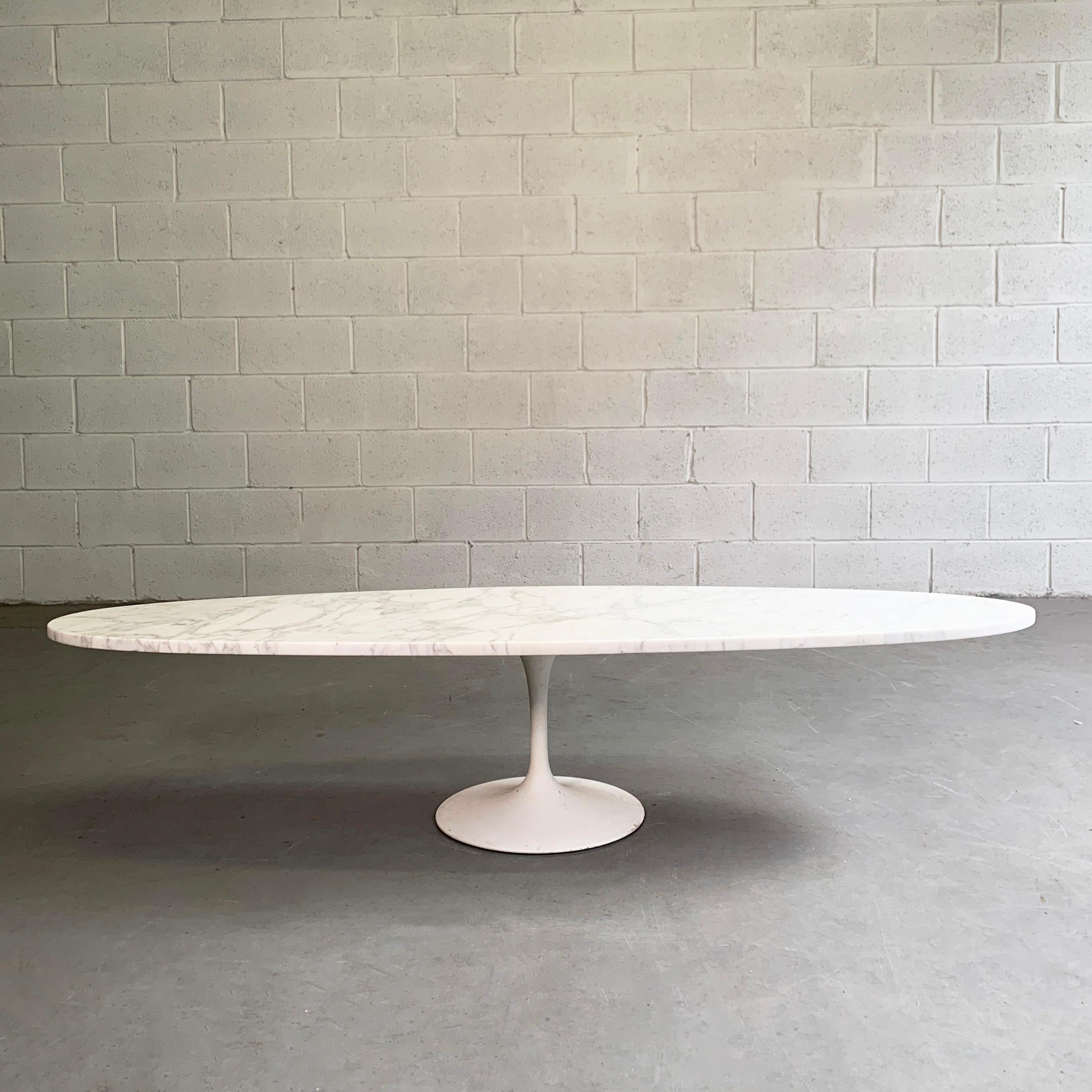 Mid-Century Modern, coffee table features an elongated oval marble top paired with a white tulip base.