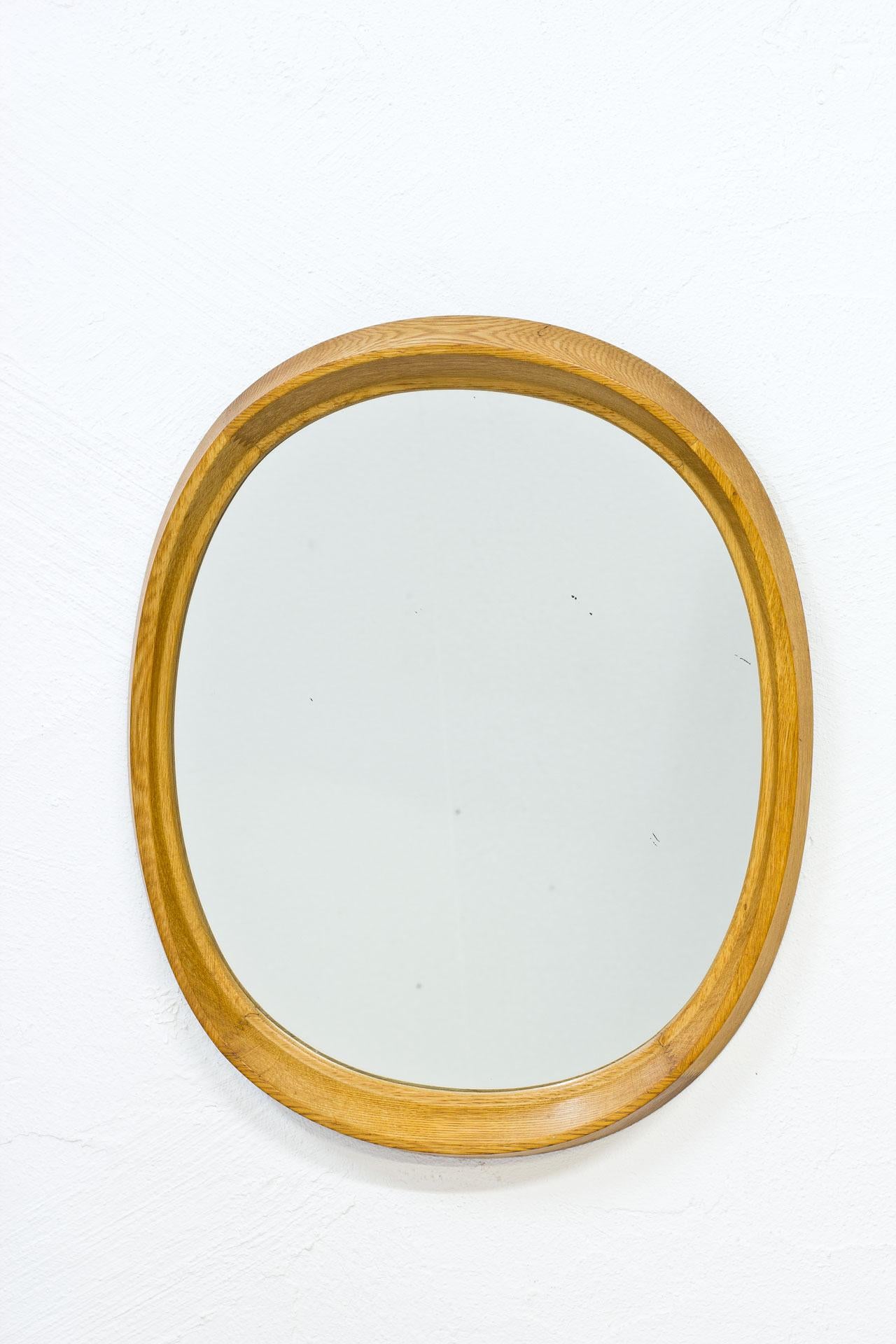 Oval shaped oak wall mirror, manufactured by Fröseke, AB Nybrofabriken during the 1950s in Sweden. Labeled in the back, model “Camilla”.
