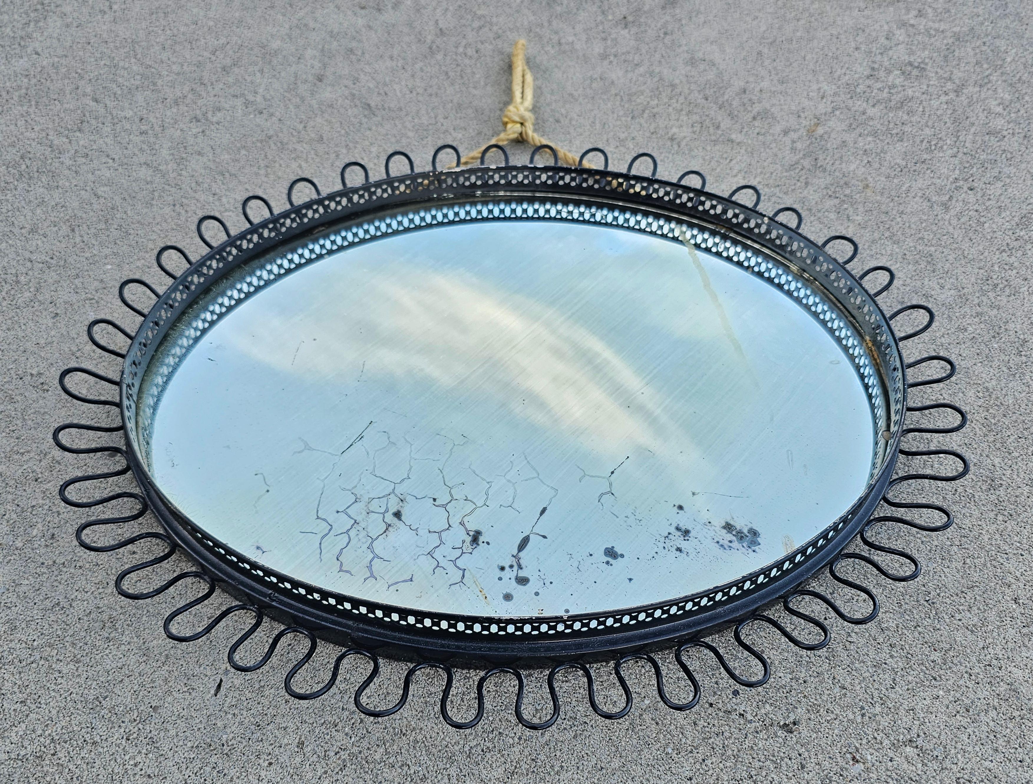 In this listing you will find beautiful and rare Mid Century Modern Oval Sunburst Mirror designed by Josef Frank. It comes with a black metal frame and the rope that allow you to mount it on the wall. Made in West Germany in 1960s.

Good vintage