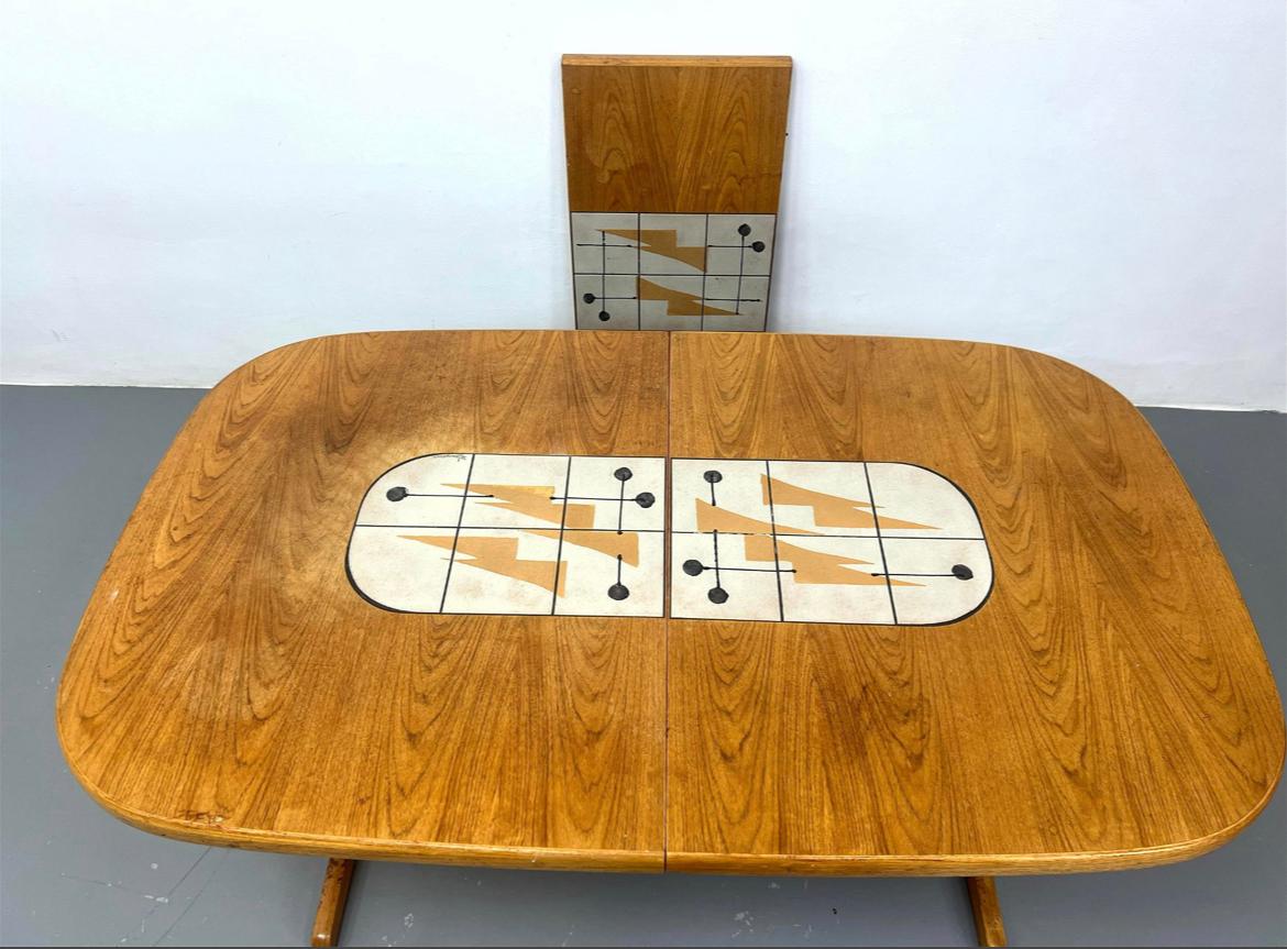 Mid century Danish Modern Teak Dining Table. Glazed ceramic tiles. Illegibly signed tiles. Center tiles allow you to place hot bowls or pots without damaging wood table surface. Made in Denmark. Good vintage condition. Really nice dining table.