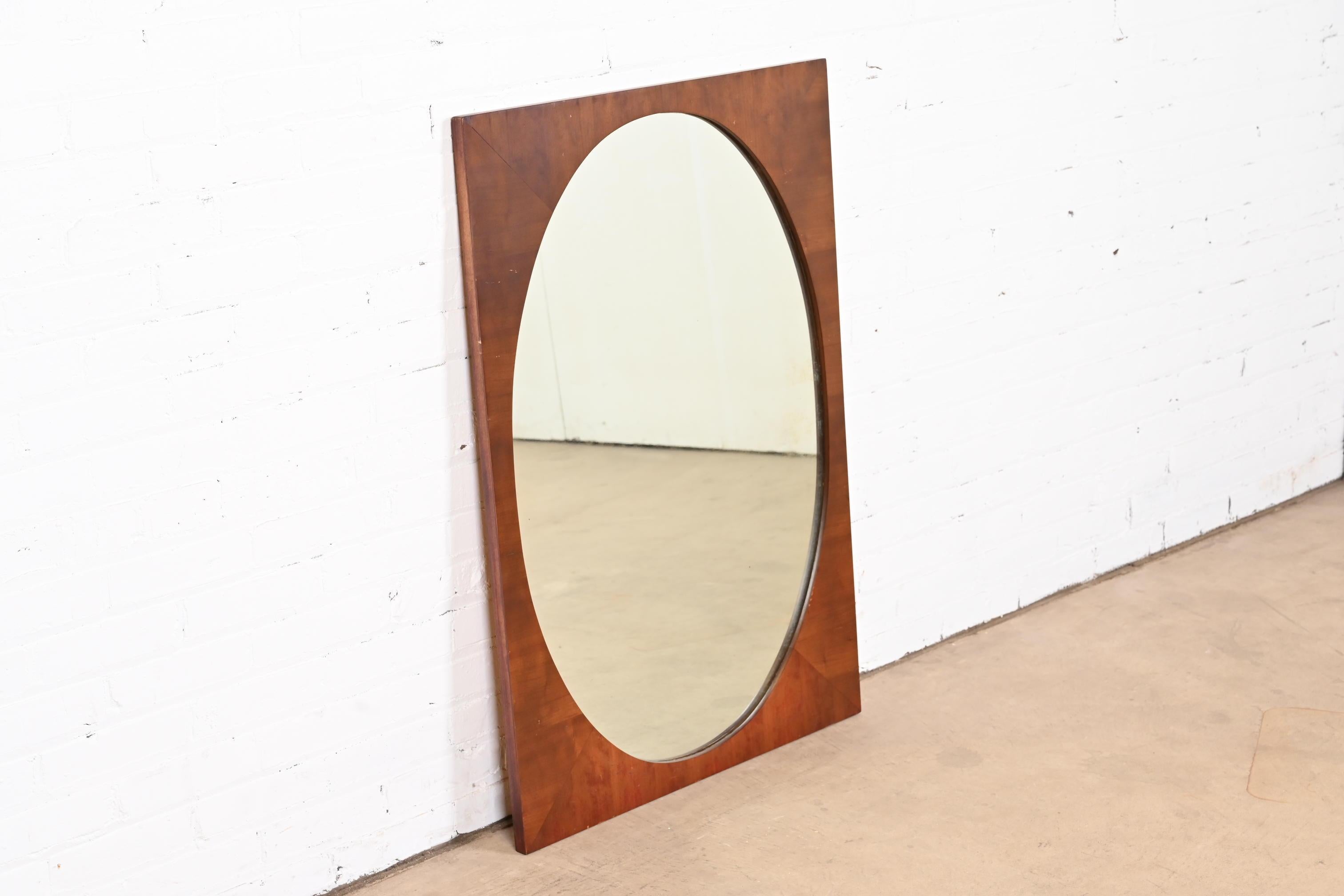 A gorgeous Mid-Century Modern oval walnut framed wall mirror

USA, Mid-20th Century

Measures: 27.5