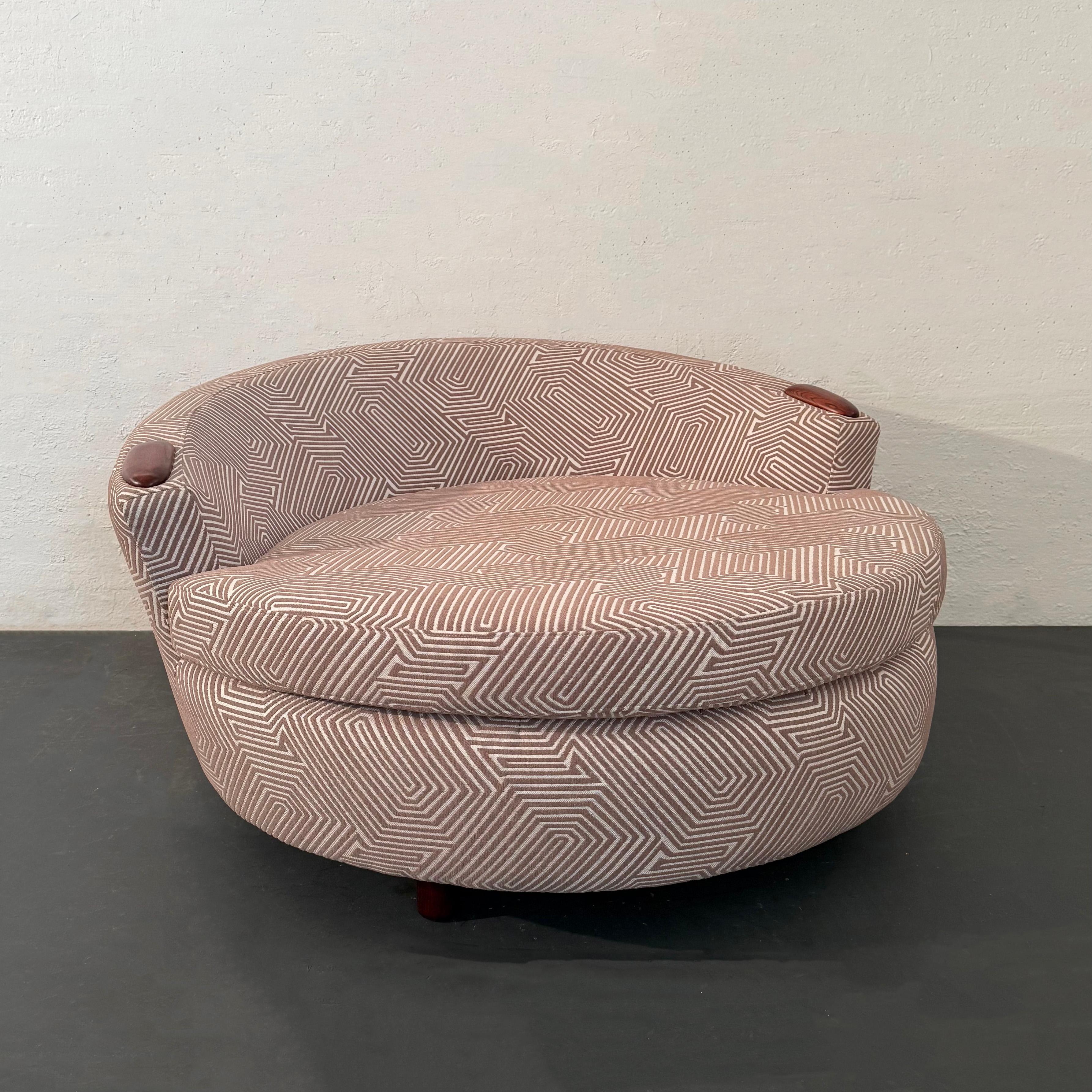 This oversized, mid-century modern, round chaise lounge chair follows the form and feel of the 