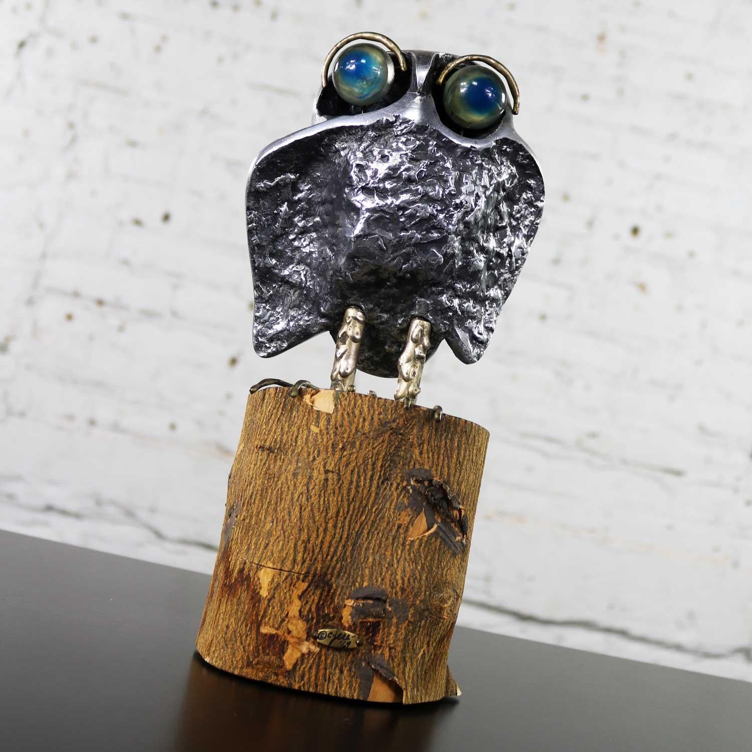 Handsome cast aluminum Mid-Century Modern owl sculpture by Curtis Jere on a natural bark-on wood stump. He has great acrylic eyes. He is in wonderful vintage condition with the normal wear you would expect with age. Some of the bark is peeling but