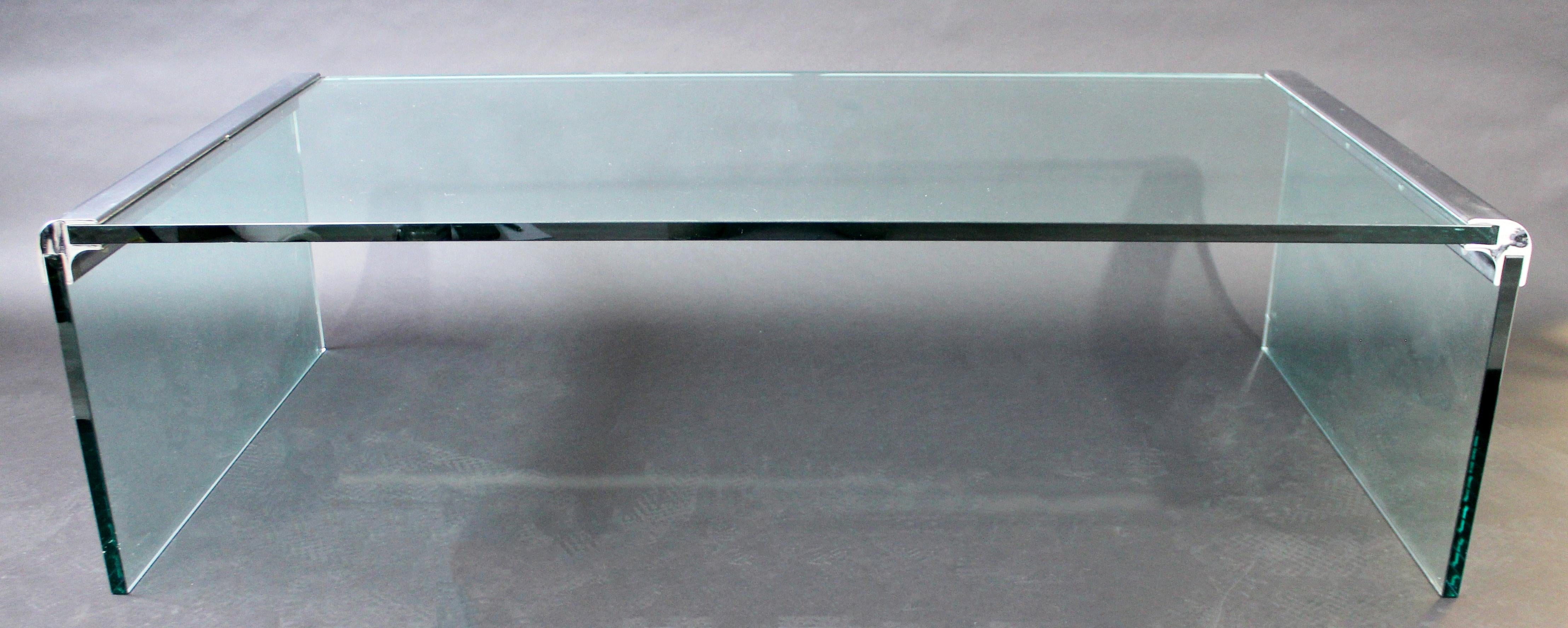 For your consideration is a wonderful, waterfall coffee table, made of chrome and three pieces of glass, by Pace, circa 1970s. In excellent condition, but with some surface scratches in the glass. The dimensions are 56.6
