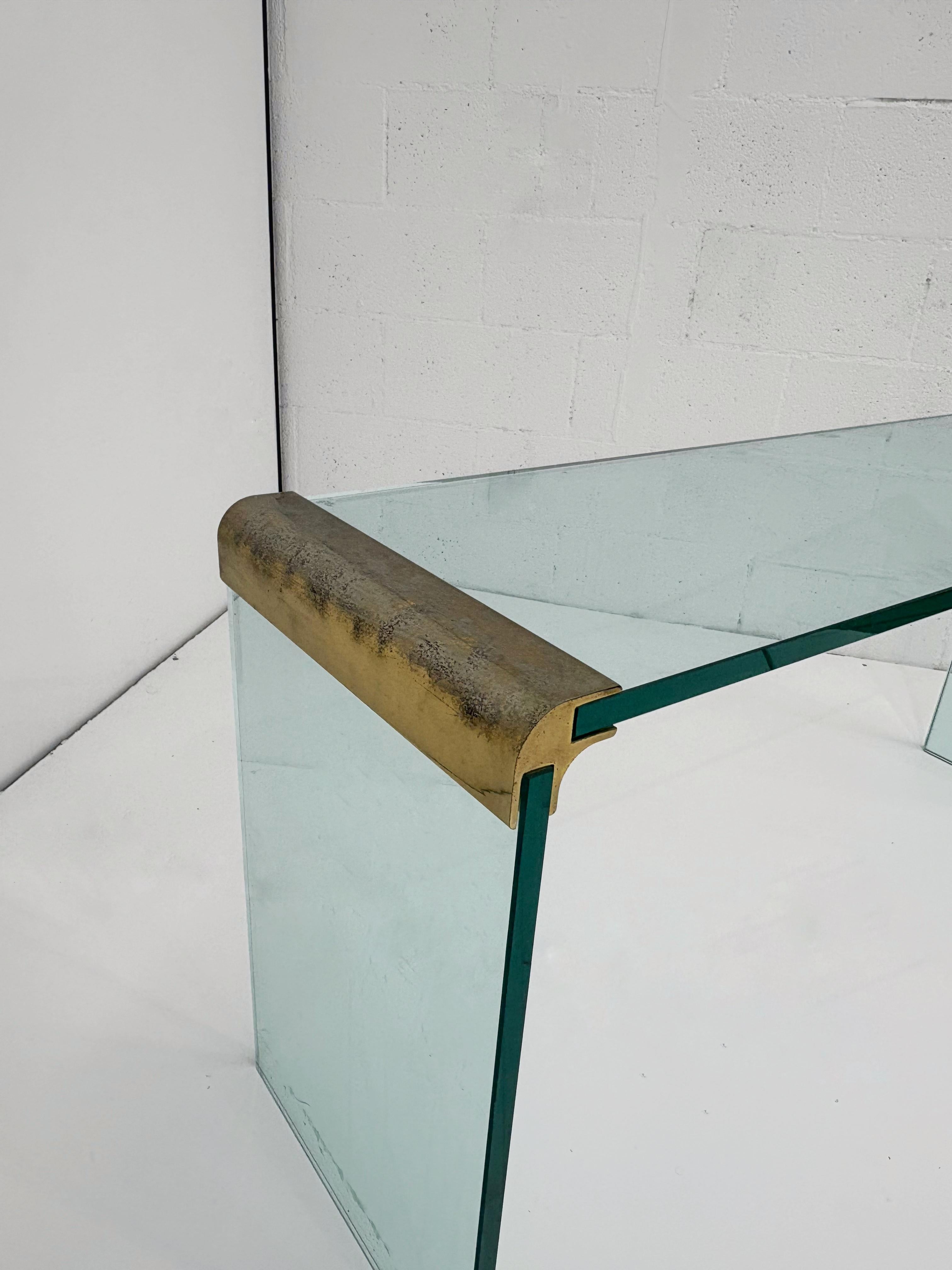 Low profile Brass and Glass Waterfall Console Table attributed to Leon Rosen for Pace Collection.
A timeless piece that is simple, understated and elegant in any home.
The console is made of 3/4