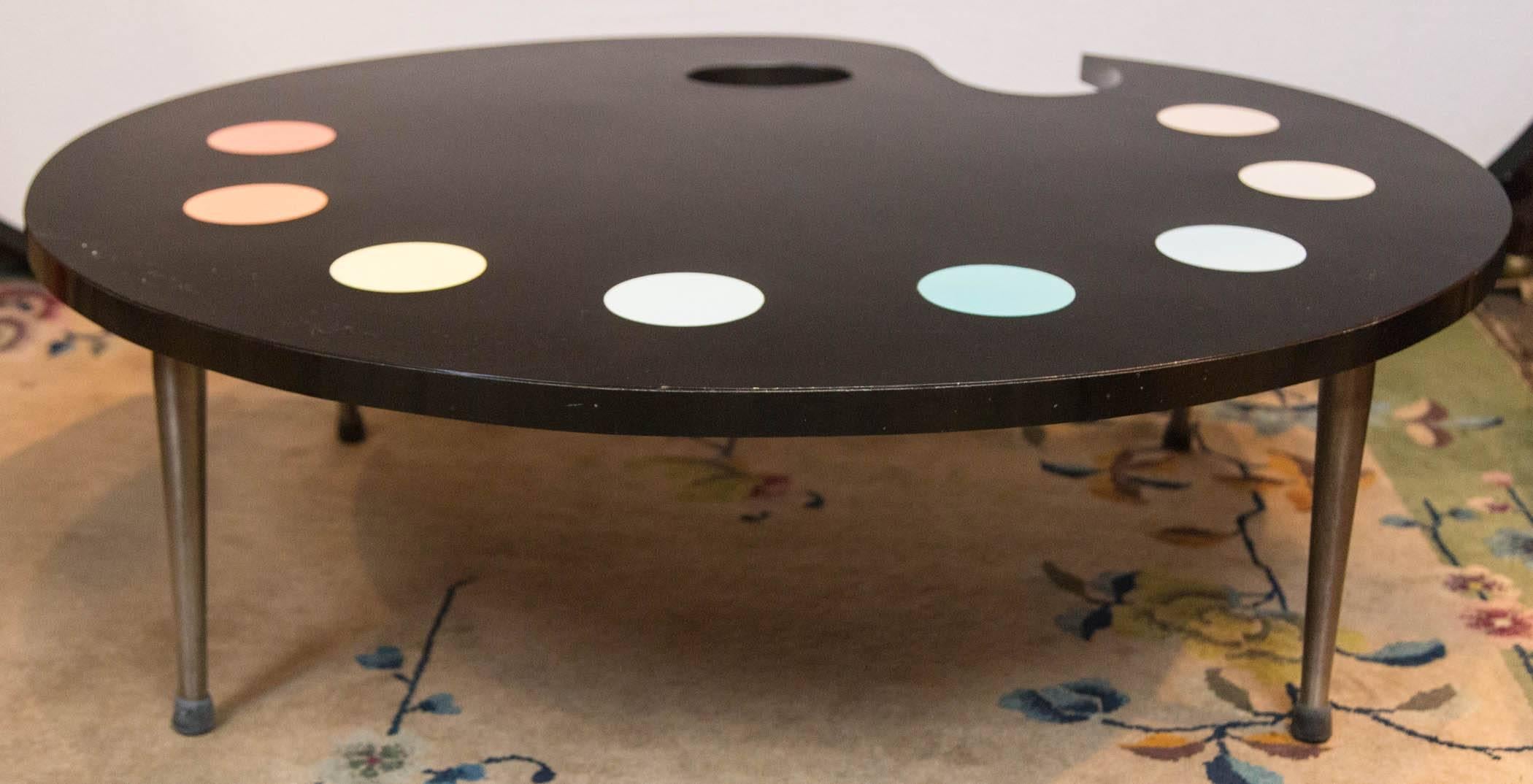 Fabulous 1950s whimsical painter's palette coffee table. The top is laminate. The legs are metal.