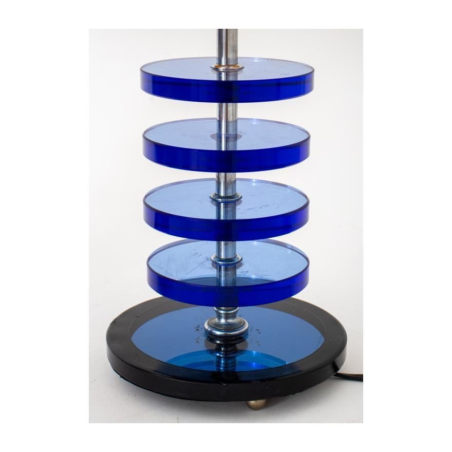 Enhance your decor with this striking pair of Mid-Century Modern Table Lamps, inspired by the Art Deco style and featuring captivating blue glass disc designs. These lamps are more than just lighting; they are exquisite pieces of functional art that