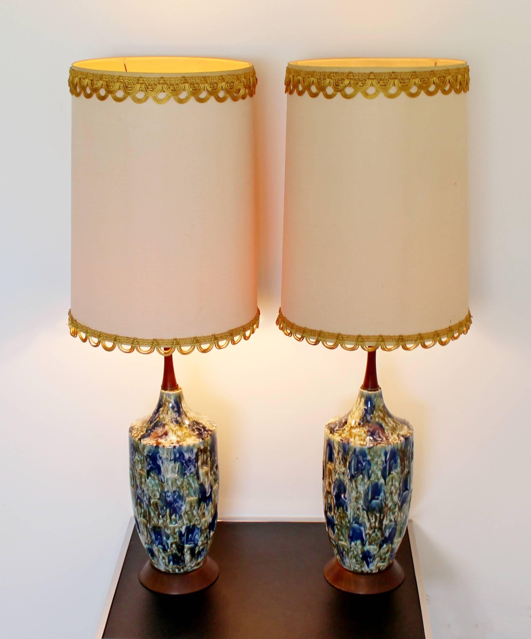 For your consideration is a phenomenal pair of blue lava drip glaze table lamps, with their original shades and finials. In excellent condition, with some staining on the shades. The dimensions are 14