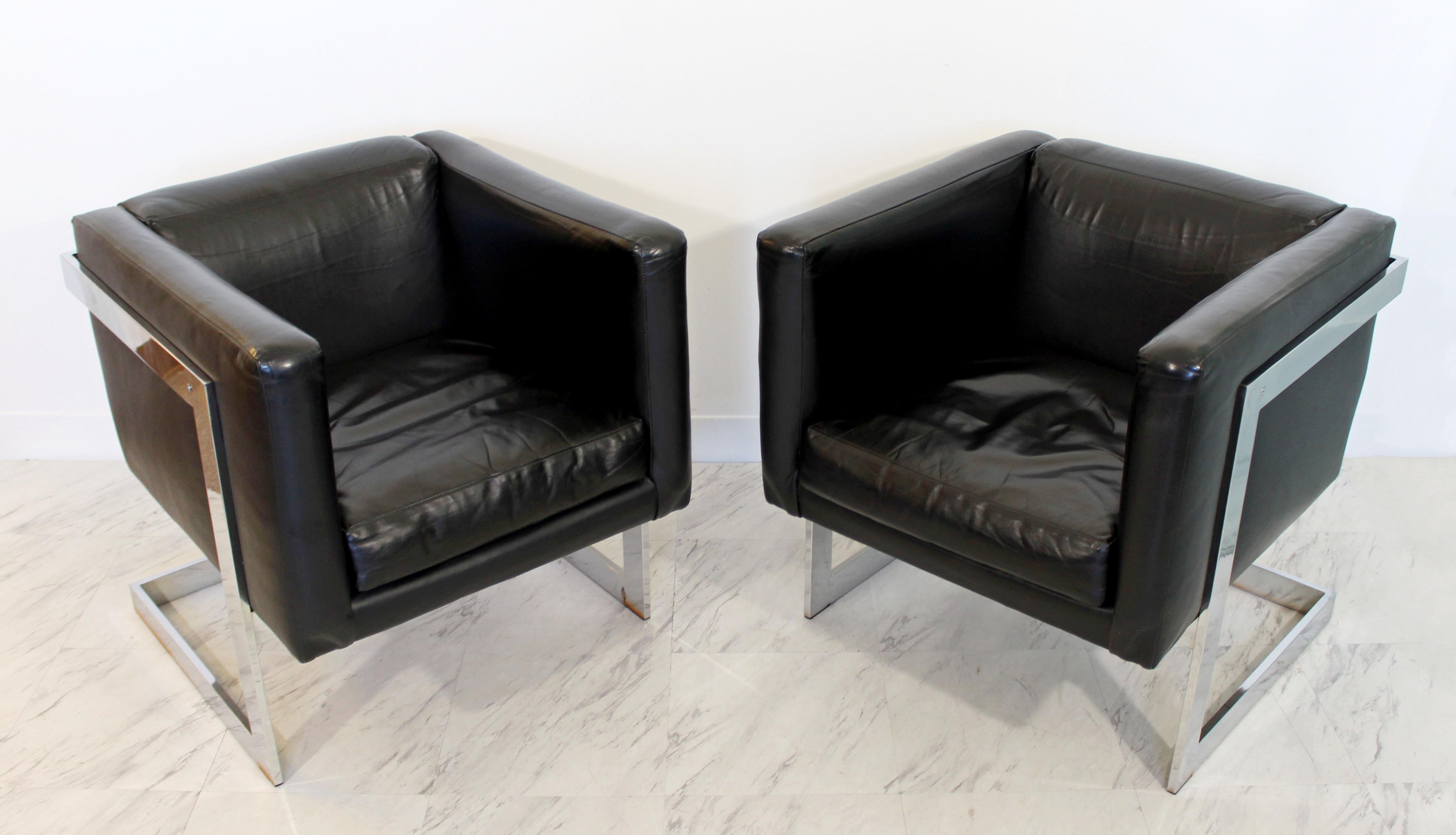 For your consideration is a fabulous pair of cube armchairs, on chrome bases and with black leather upholstery, by Milo Baughman, circa 1970s. In very good condition. The dimensions are 23