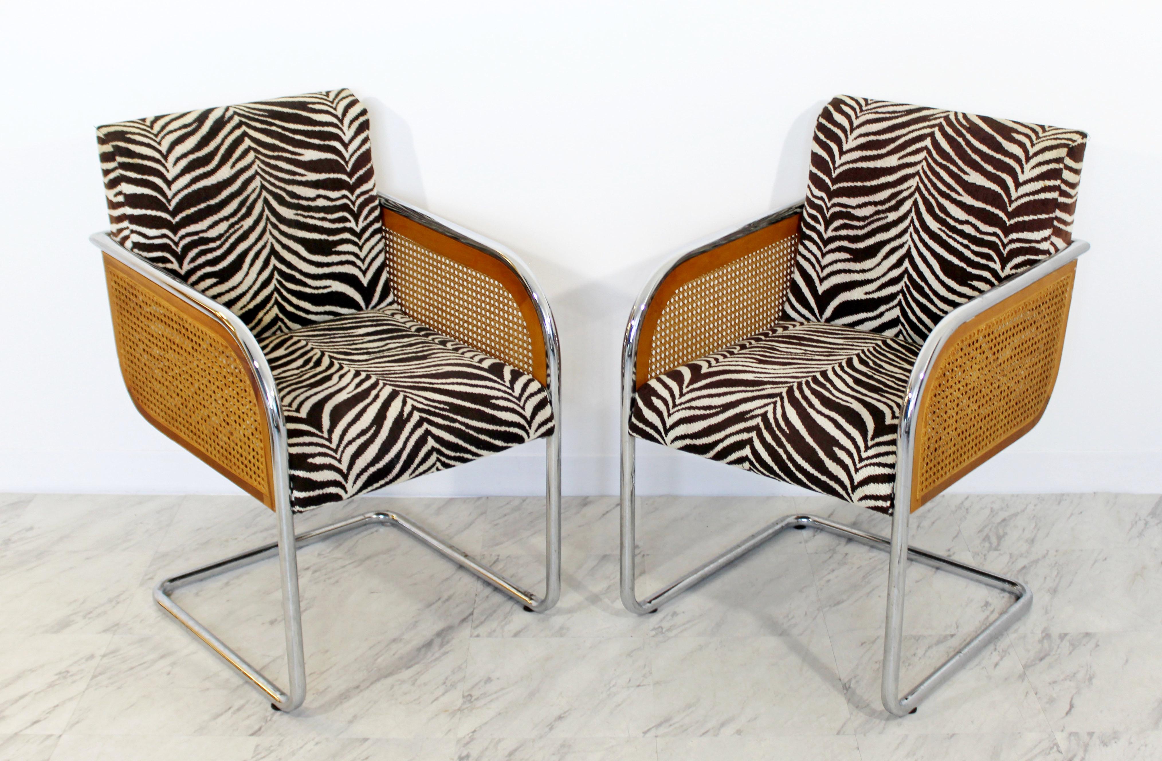 For your consideration is a gorgeous pair of chrome and rattan, cantilever armchairs, with a zebra striped upholstery, in the style of Marcel Breuer or Milo Baughman, circa the 1970s. In excellent condition. The dimensions are 21