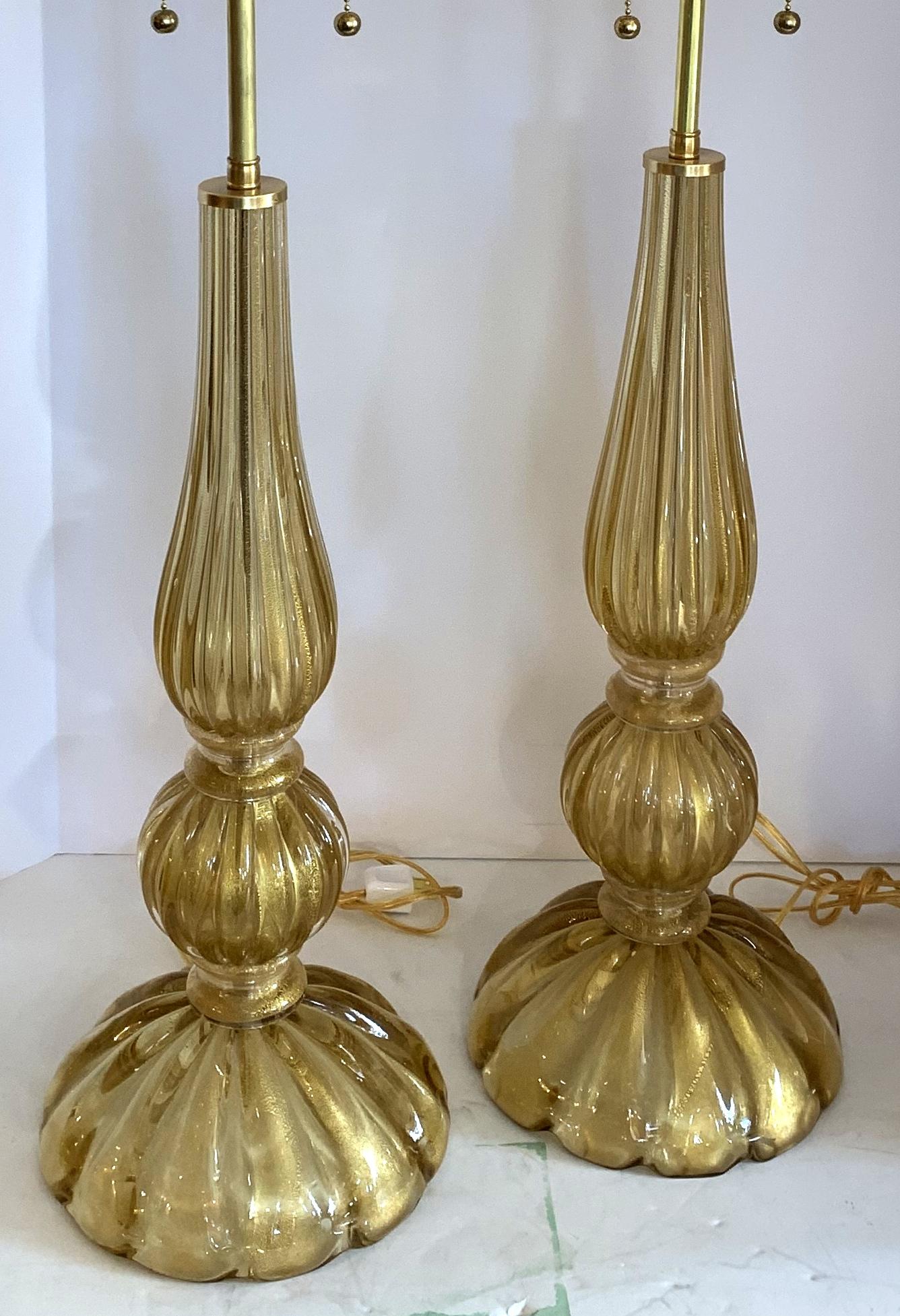 A wonderful pair of Mid-Century Modern Italian Murano Seguso style Venetian champagne gold fluted glass lamps in the Art Deco style with new brass fittings and wiring.
Purchased from Lorin Marsh.