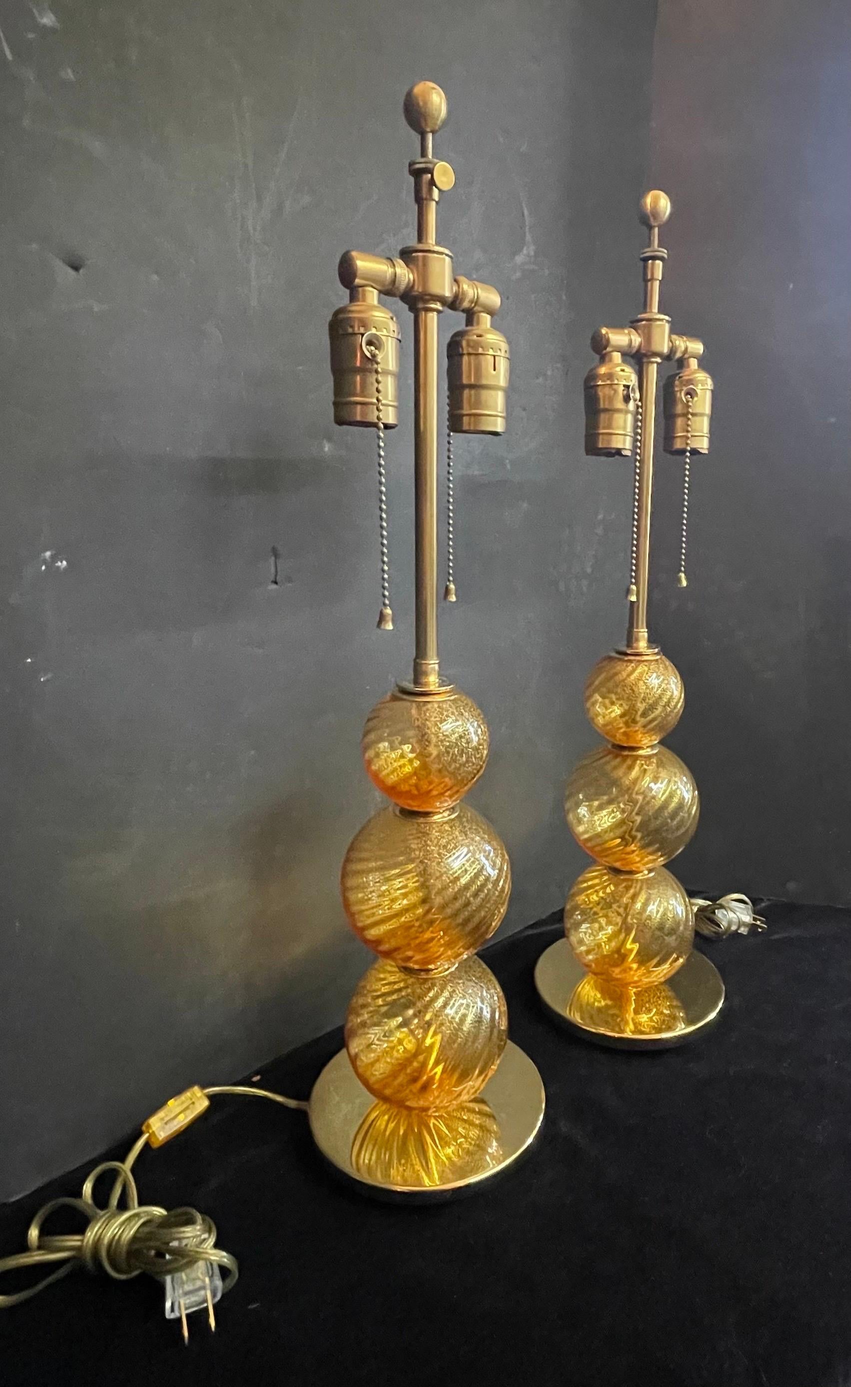A wonderful vintage pair of Mid-Century Modern Italian venetian swirl signed murano gold flake glass lamps retailed by Lorin Marsh.