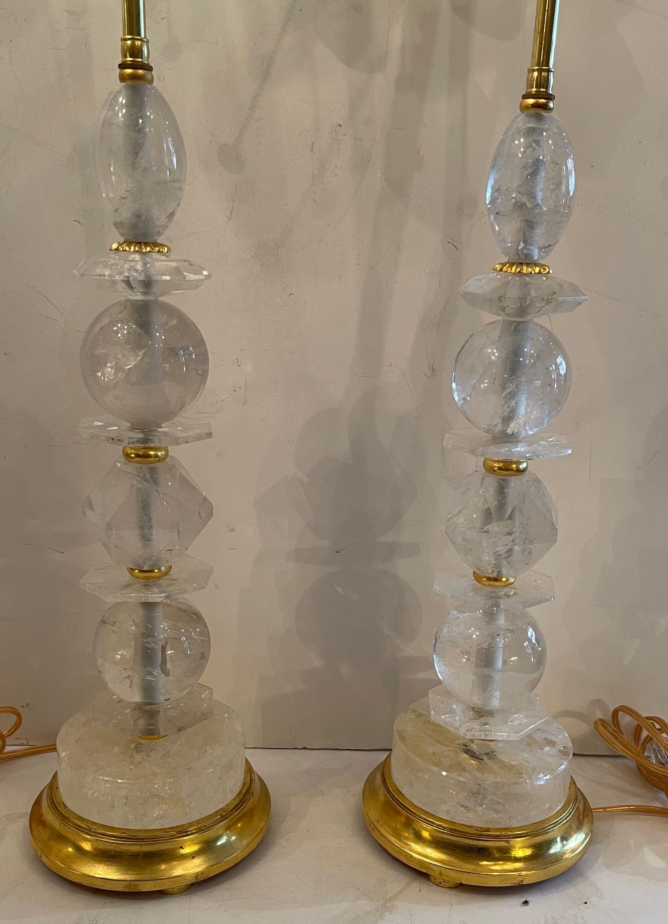 A Wonderful Pair of Mid-Century Modern Large various forms rock crystal stacking raised on gold leaf wood bases, rare fine table lamps in the manner of Maison Baguès.
Each with two new Edison sockets and rewired for US.
