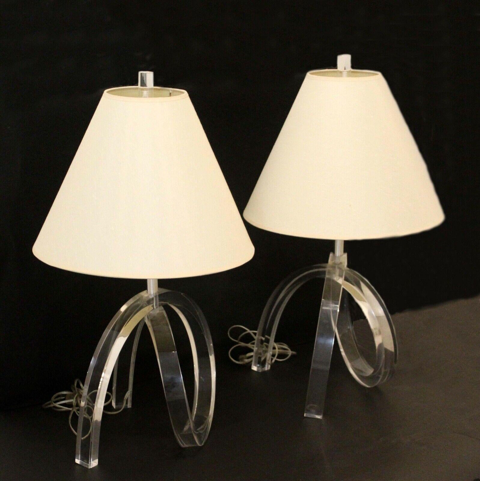 This stunning pair of clear, lucite table lamps with original finials were designed by Herb Ritz and Astrolite, Los Angeles and referred to as the 'pretzel' lamp. In good vintage condition with little or no imperfections.
 