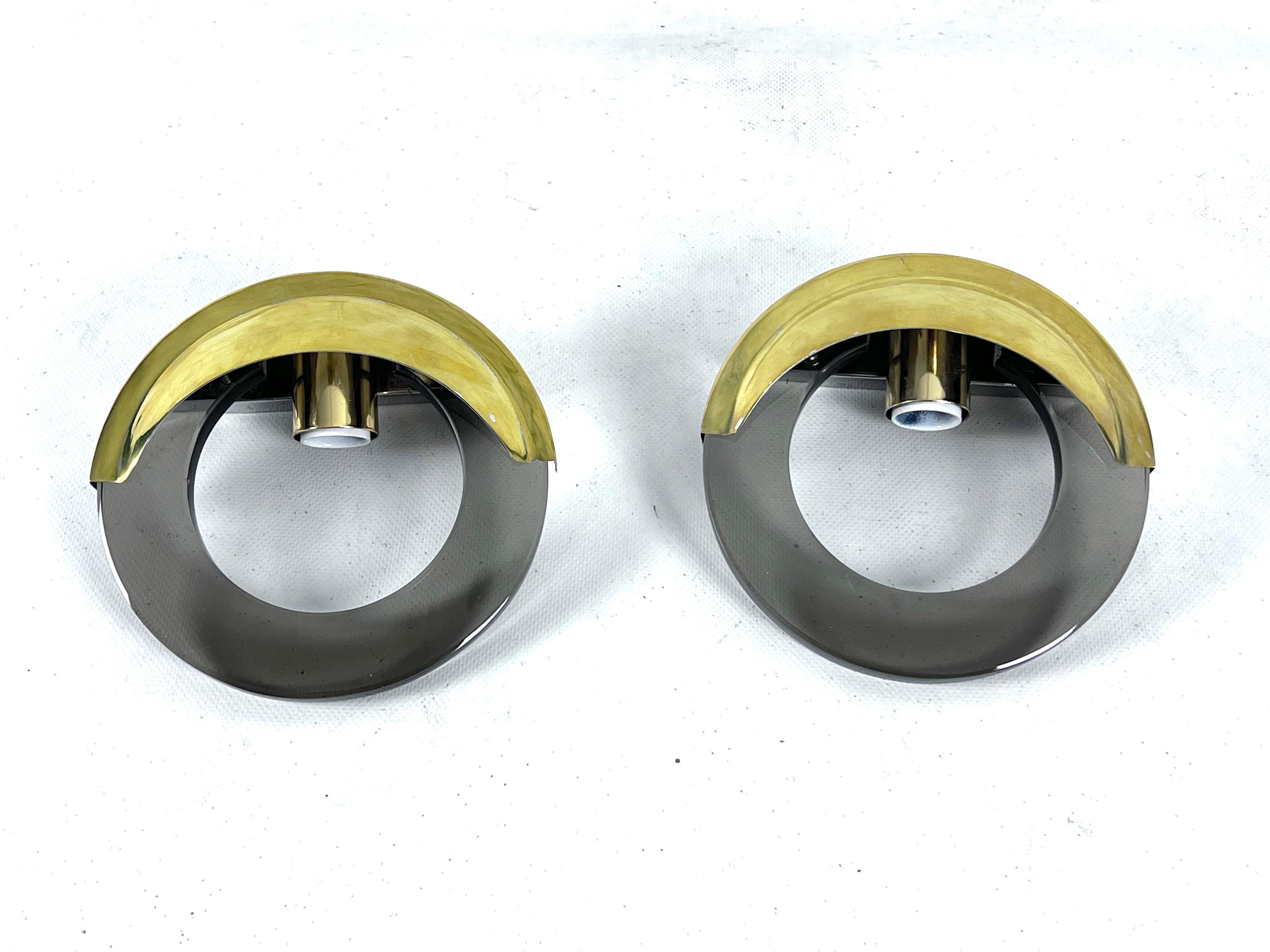 Brass Mid-Century Modern pair of brass and thick smoked glass sconces. Italy 1970s For Sale