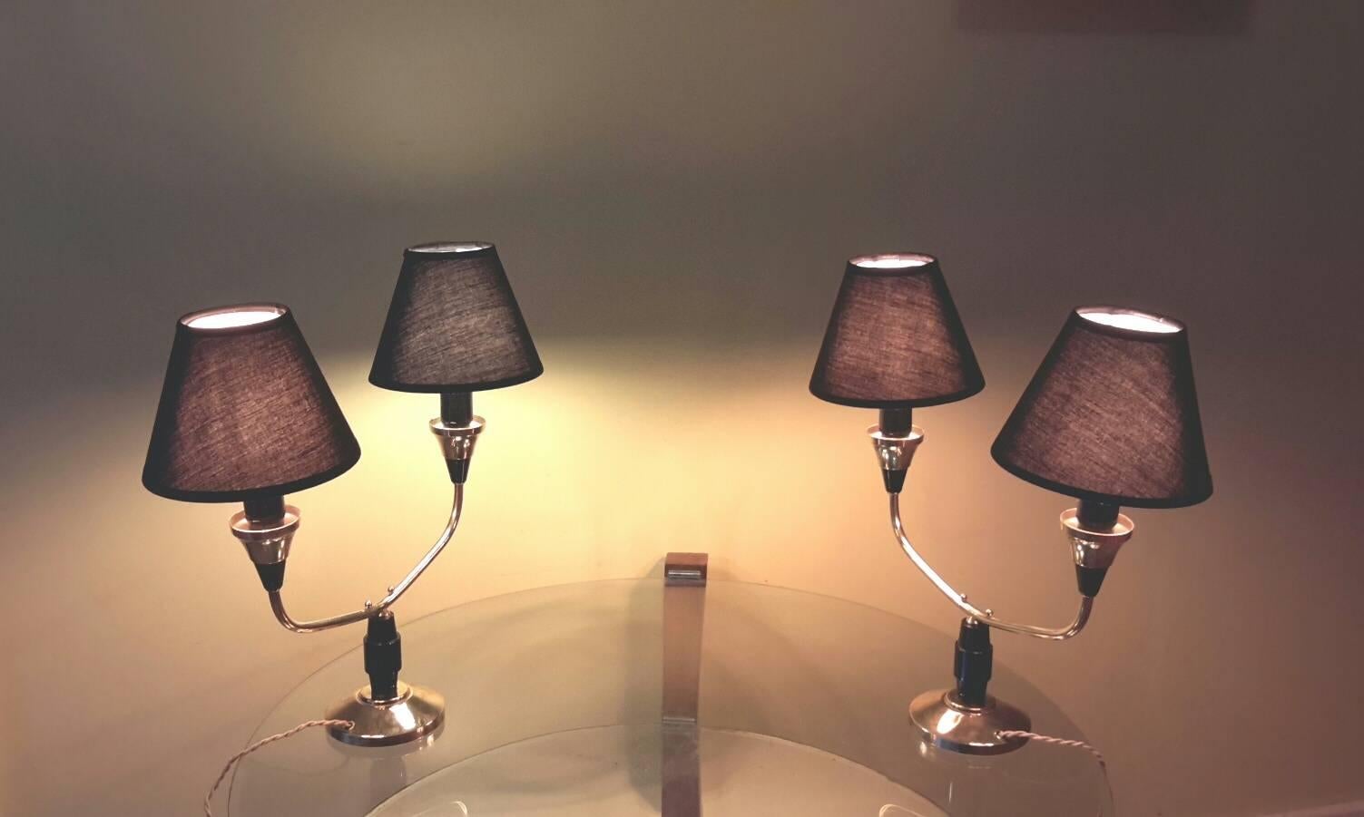 Very elegant 1950s pair of French two-arm table lamp with two lighting in brass and bakelite with black cotton shades.
The pair is in excellent condition rewired and fit to the US standard.
Black cotton shade are new
Max 40 watts per