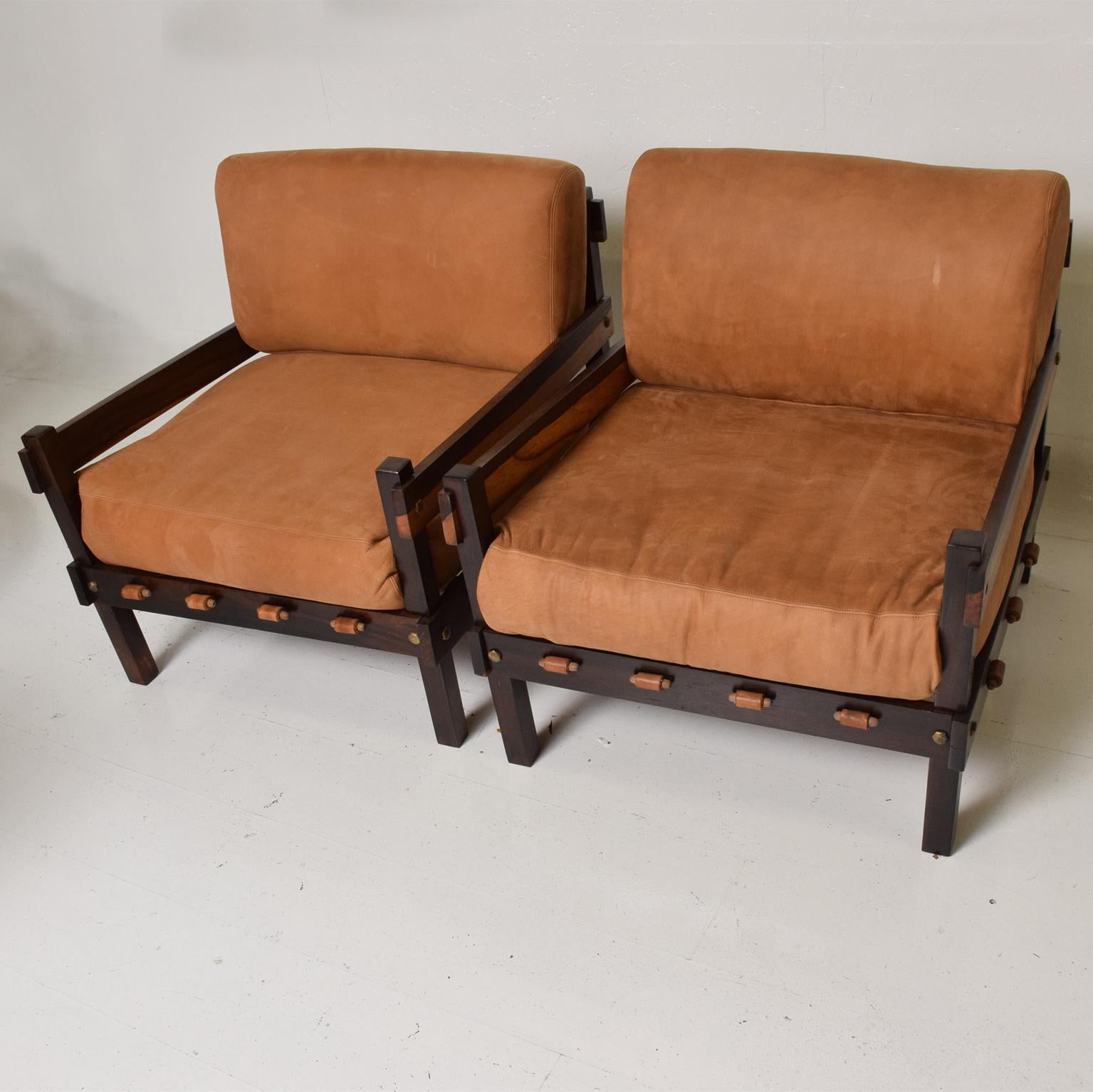 For your consideration, a Mid-Century Modern pair of Brazilian rosewood armchairs.
Solid Brazilian rosewood with brass accents and leather cushions. One chair retains original label.
Dimensions: 31