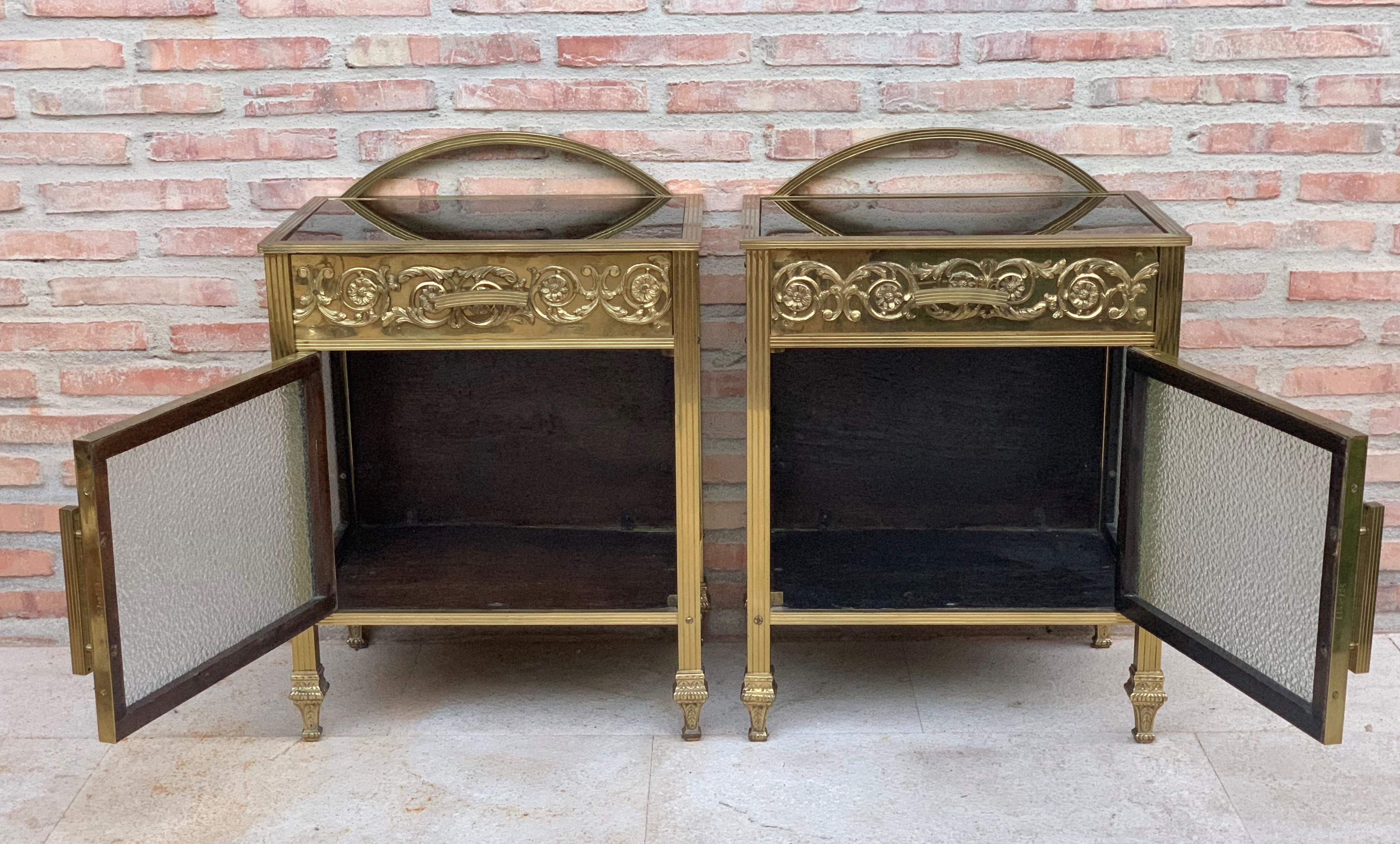 20th century pair of bronze nightstands with glass door and drawers.

This bronze or glass vitrine cabinet or nightstand is simply stunning and constructed of the finest quality. The bronze mounts of Fine form with a single drawer over an open