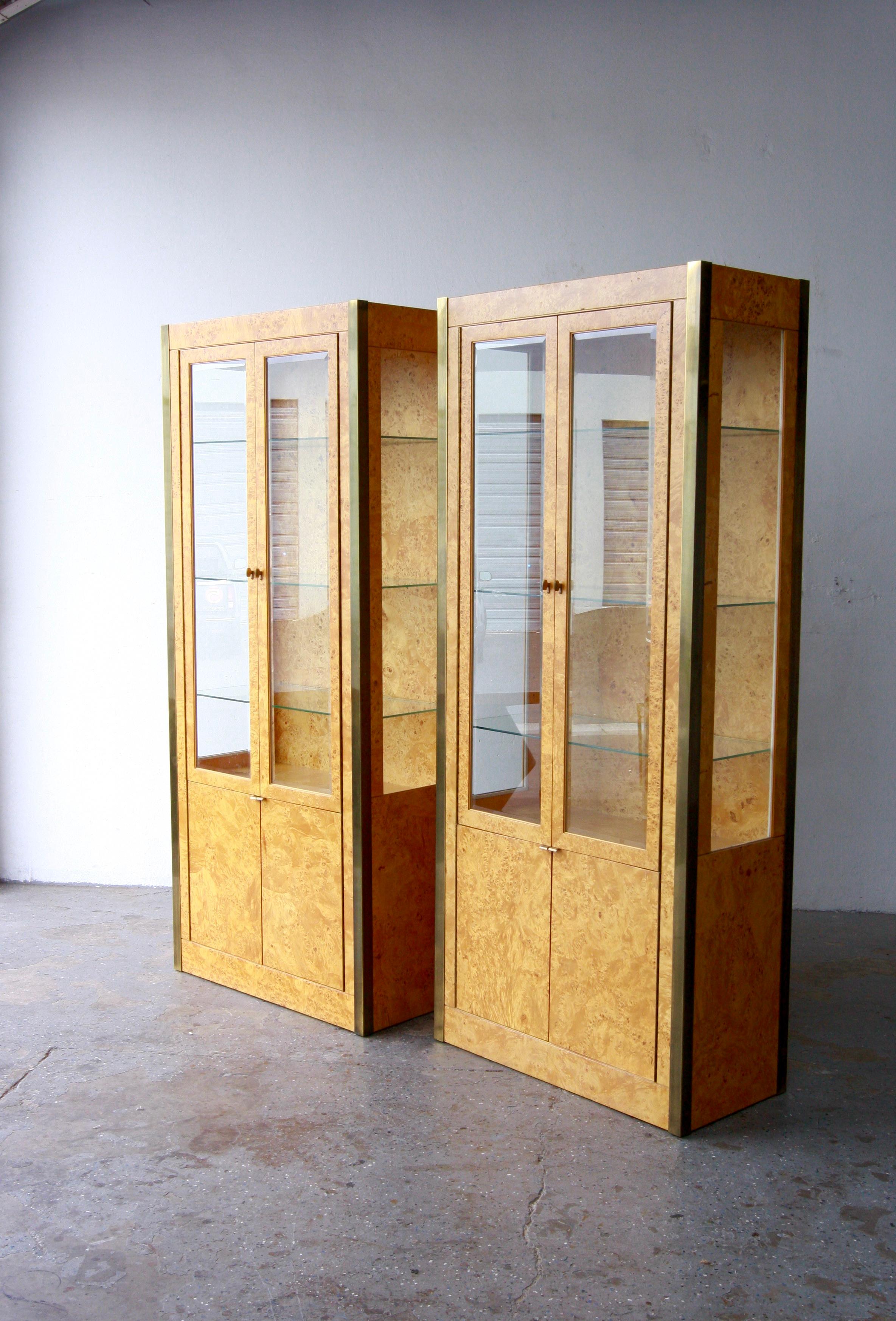 Pair of Tomlinson Burl Wood & Brass Vitrine cabinets 
Exquisite 1970’s  burl wood and brass vitrine cabinets,  exceptional quality, feature glass doors that open to reveal adjustable glass shelves within.

Each is 34 inches wide 16 inches deep, 78