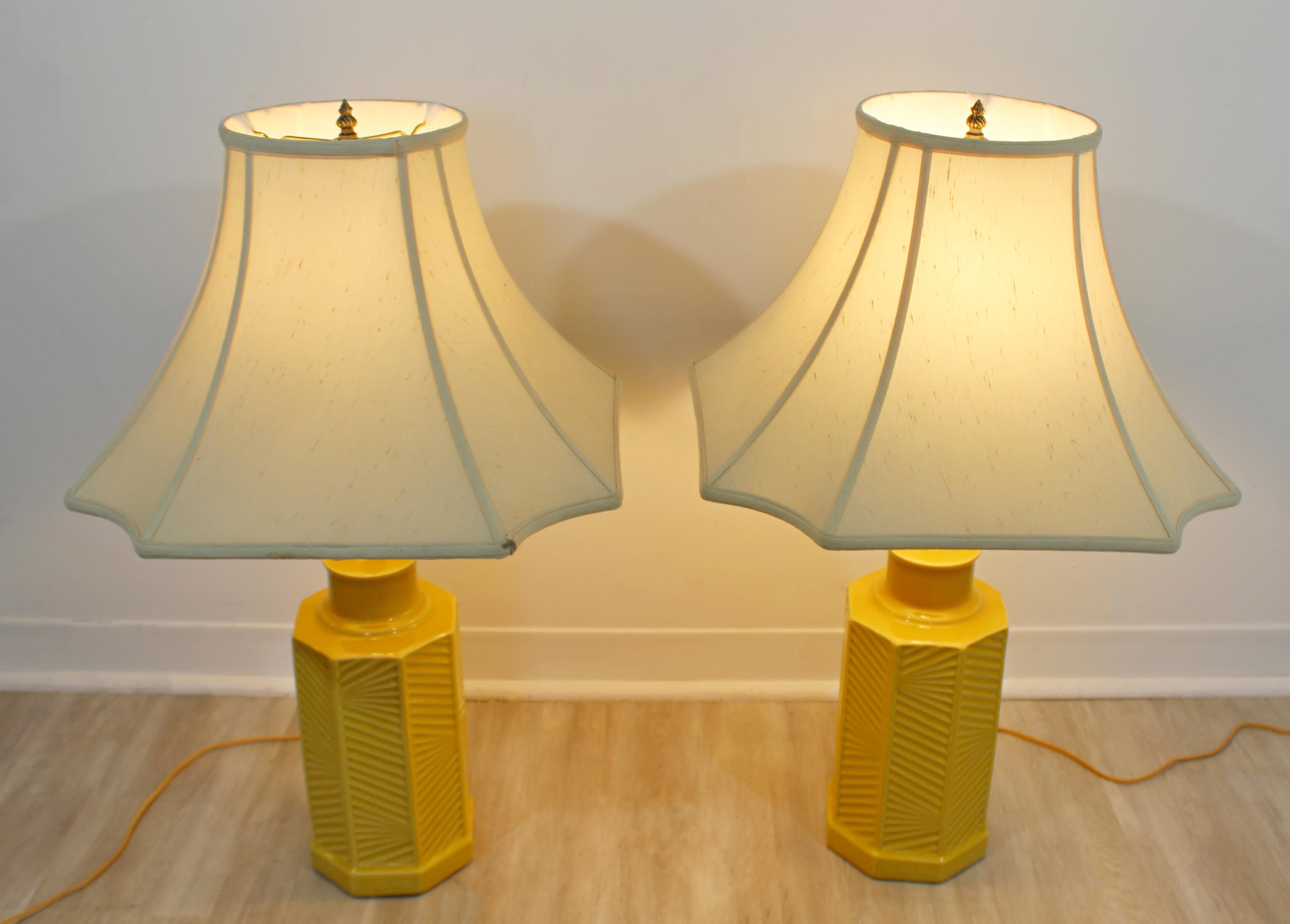 For your consideration is a fabulous pair of chinoiserie style, yellow ceramic table lamps, with Asian shades, circa 1970s. In excellent vintage condition. The dimensions of the shades are 18